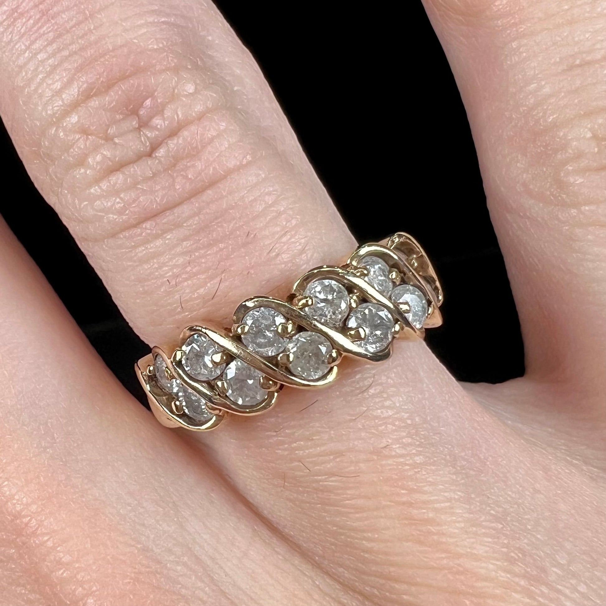 A ladies' estate yellow gold band set with 1 total carat of round brilliant cut diamonds.