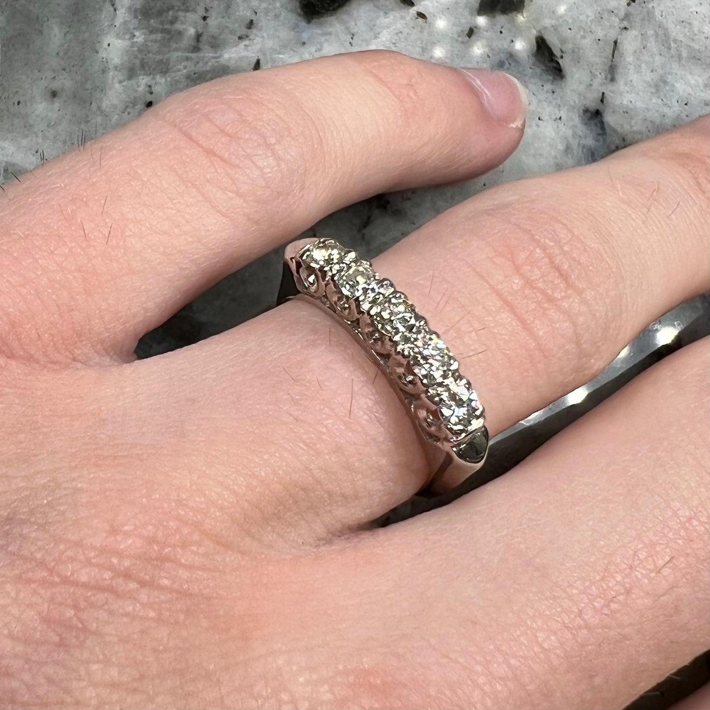A vintage style ladies' platinum wedding band set with five round diamonds.