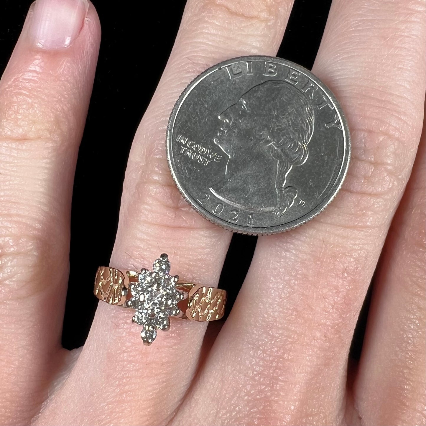 A ladies' estate diamond cluster ring cast in yellow gold. The shank has a nugget design.