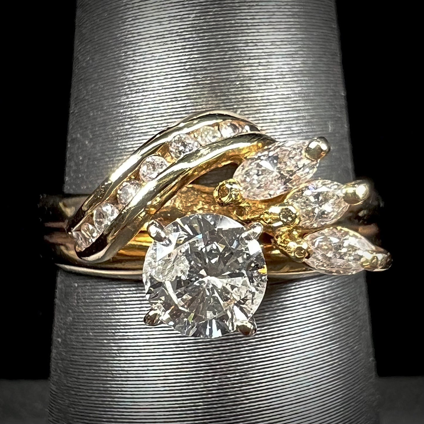 A ladies' diamond wedding set that has been soldered together in yellow gold. There are round and marquise cut diamonds.