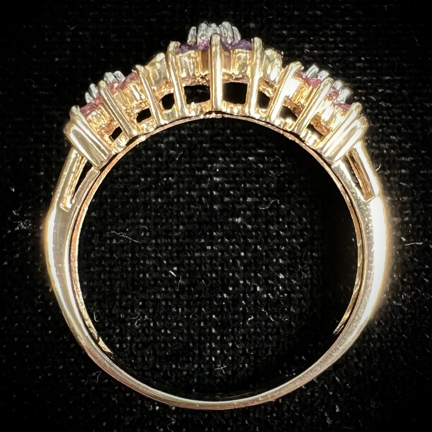 A vintage ladies' flower ring set with set with amethyst and pink tourmaline petals with a diamond center stone.