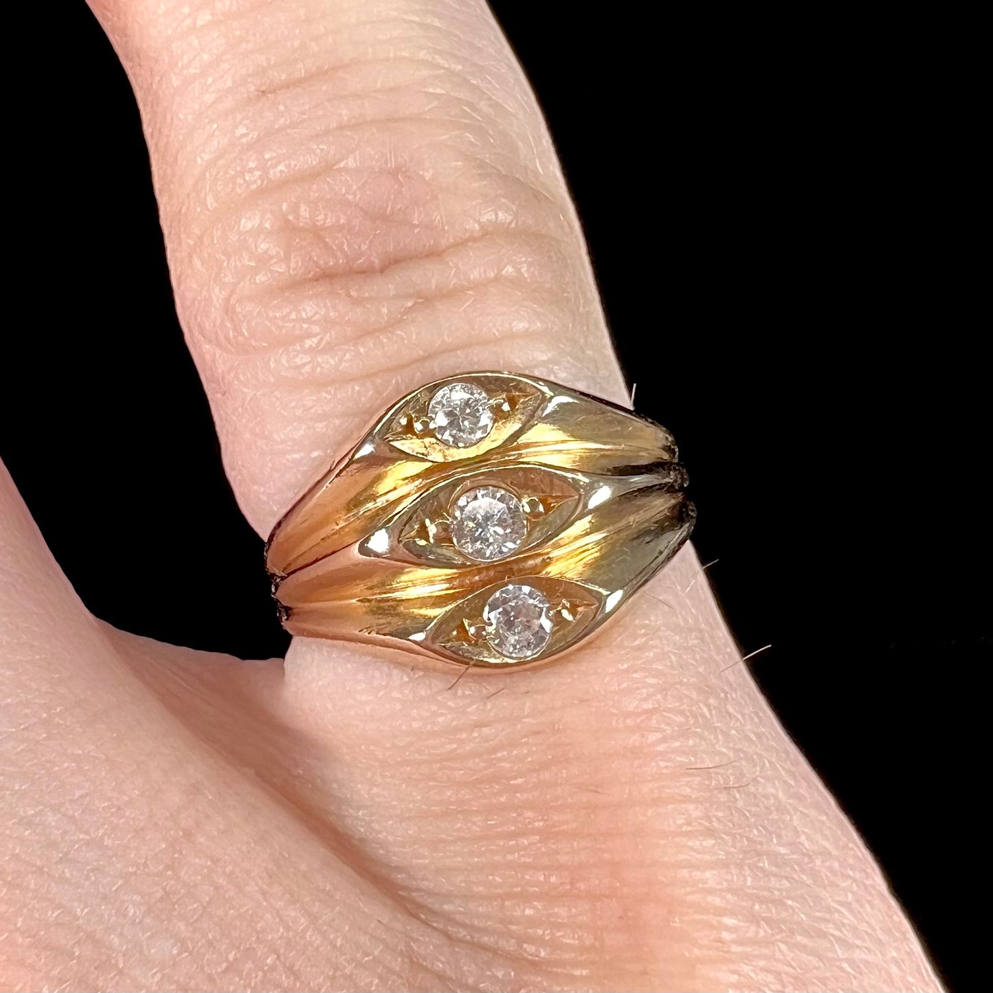 A vintage 1940's style ladies' yellow gold three stone diamond ring.