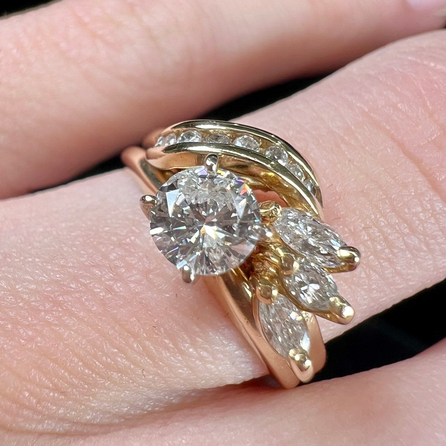 A ladies' diamond wedding set that has been soldered together in yellow gold. There are round and marquise cut diamonds.