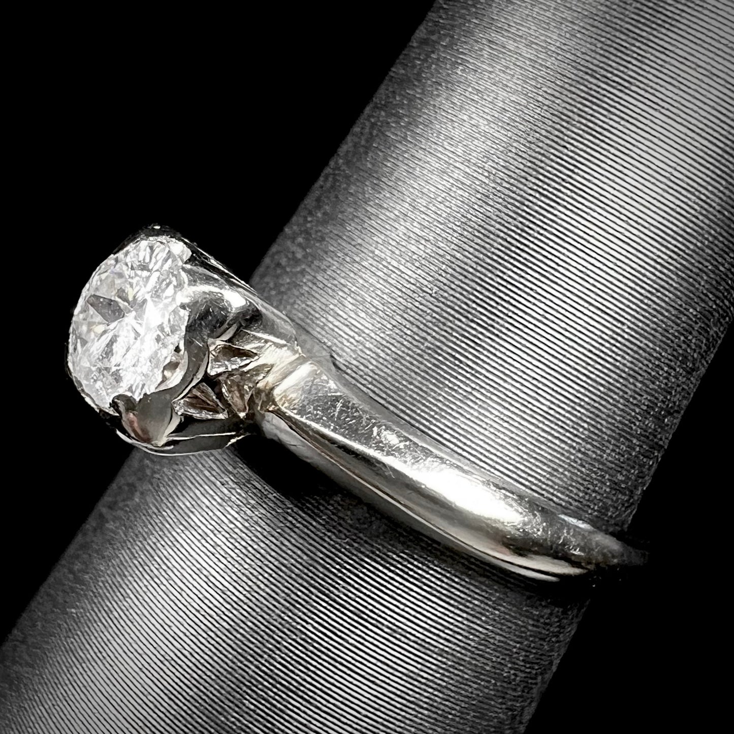 A ladies' vintage 14kt white gold 1940's diamond solitaire ring. The diamond is chipped in two places.