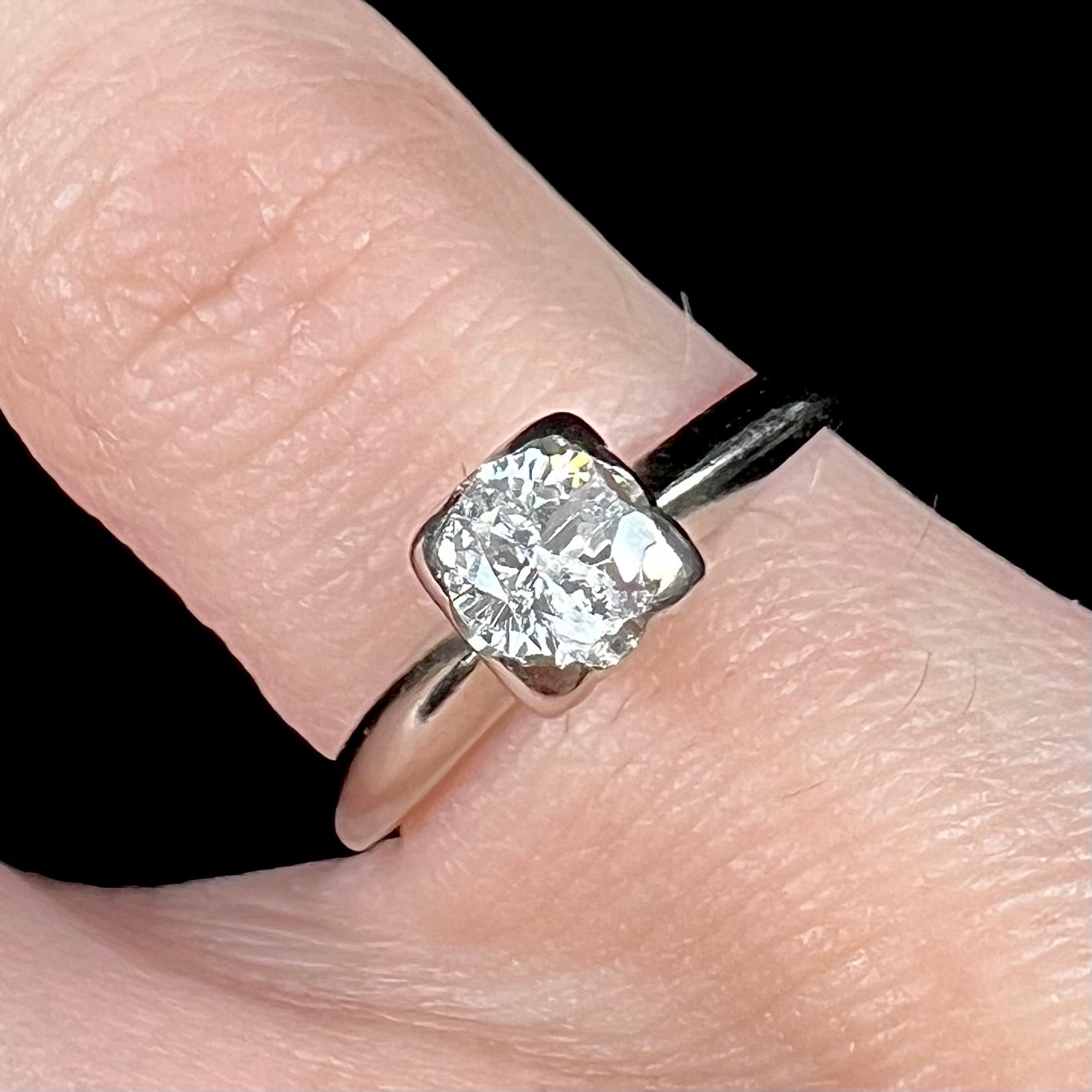 A ladies' vintage 14kt white gold 1940's diamond solitaire ring. The diamond is chipped in two places.