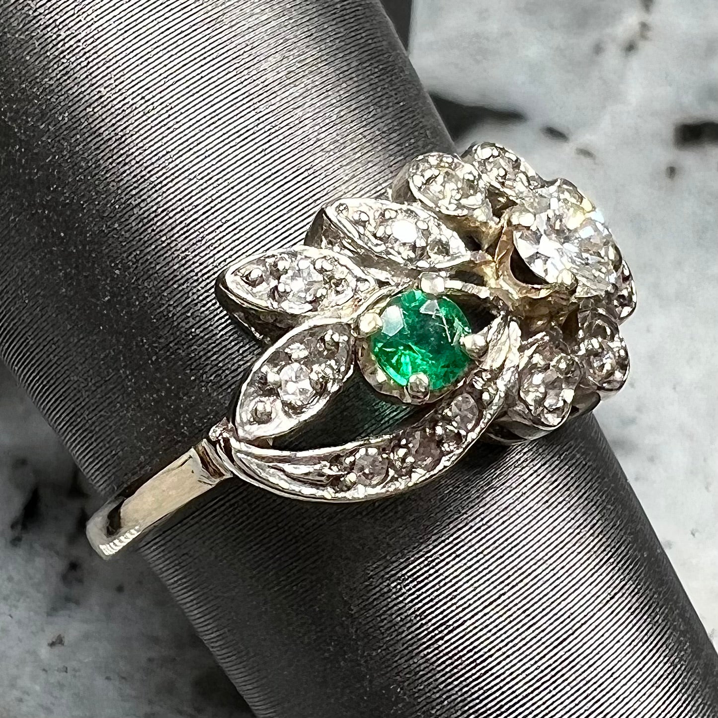 Vintage gold round cut emerald and diamond ring.