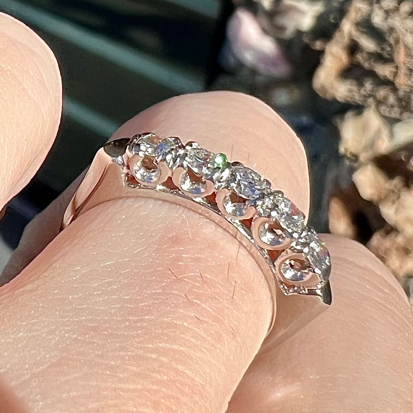 A vintage style ladies' platinum wedding band set with five round diamonds.