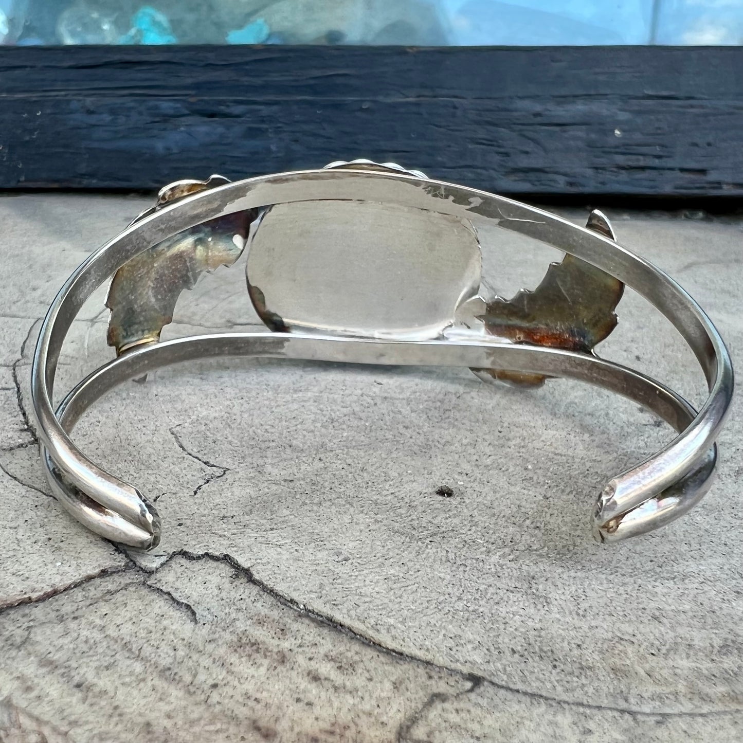 A sterling silver Navajo cuff bracelet set with a Royston turquoise stone.
