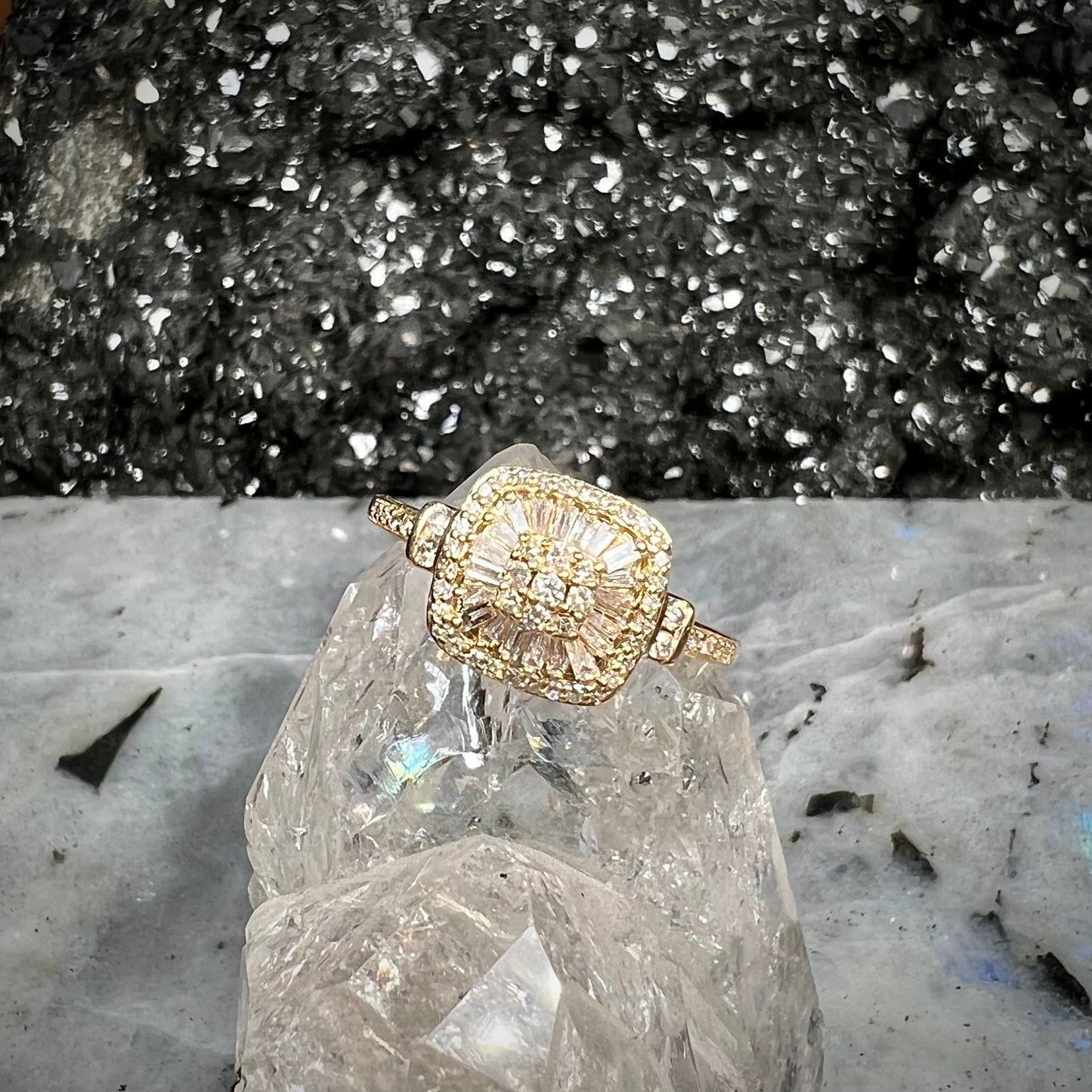A 1930's style yellow gold diamond cluster ring set with round and baguette cut diamonds.
