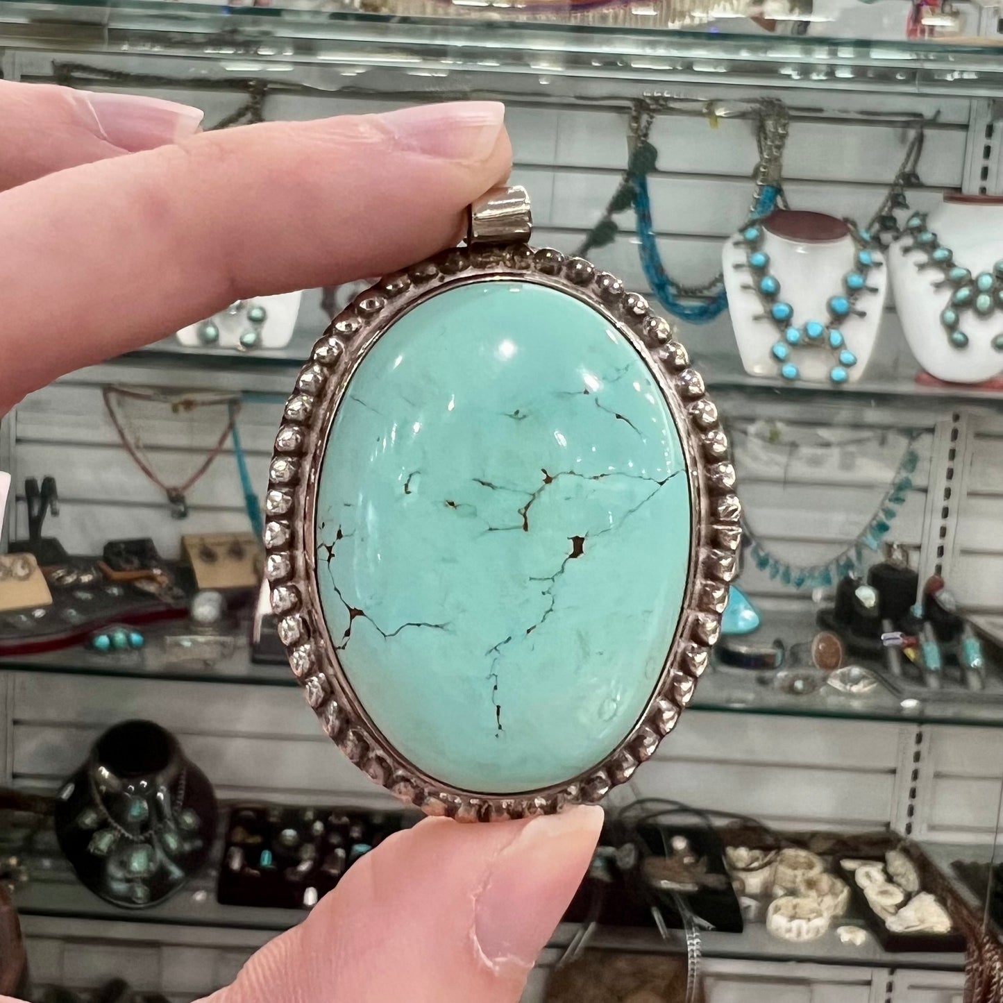 A sterling silver Native American pendant set with a piece of blue turquoise from Courtland-Gleeson Mining District, Arizona.