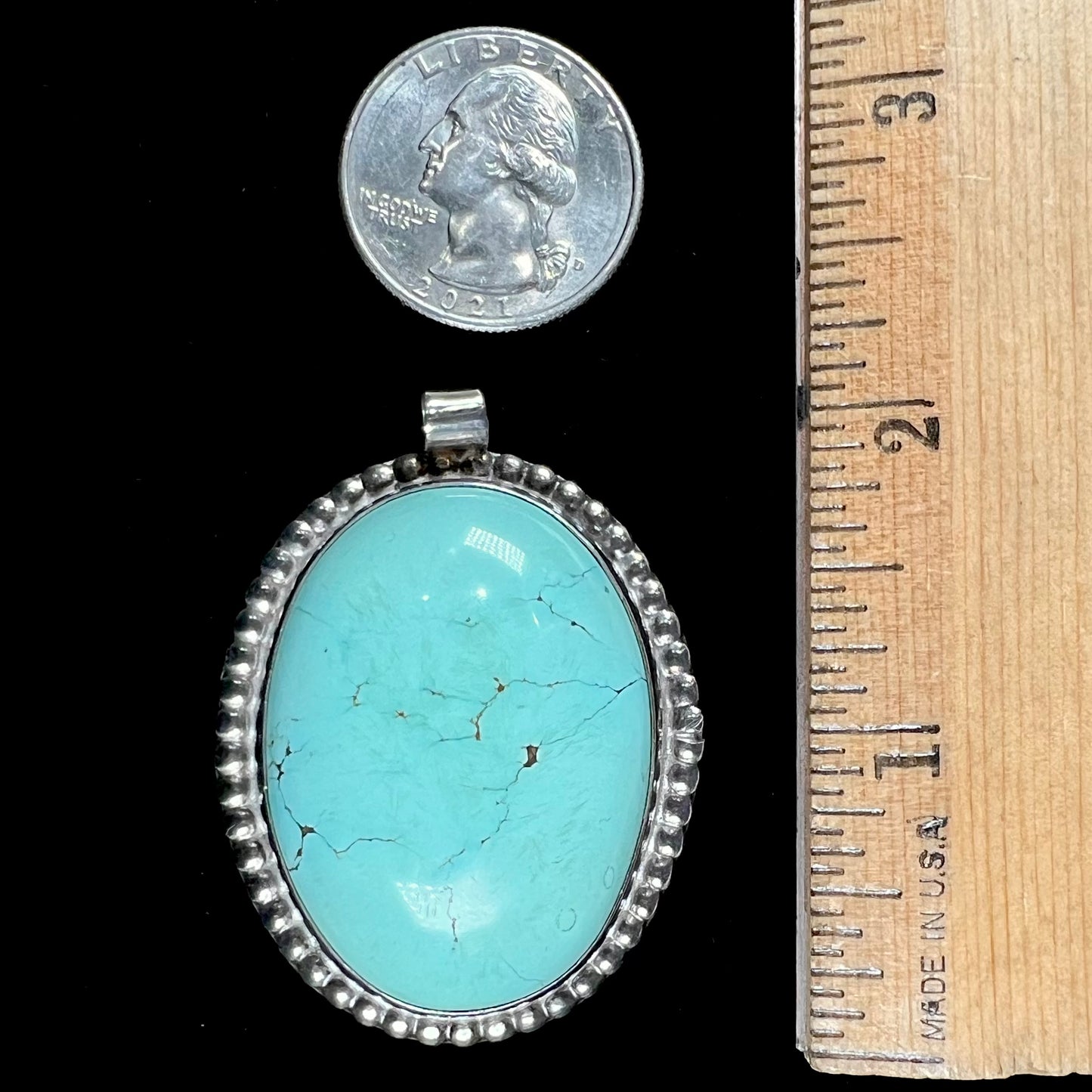 A sterling silver Native American pendant set with a piece of blue turquoise from Courtland-Gleeson Mining District, Arizona.