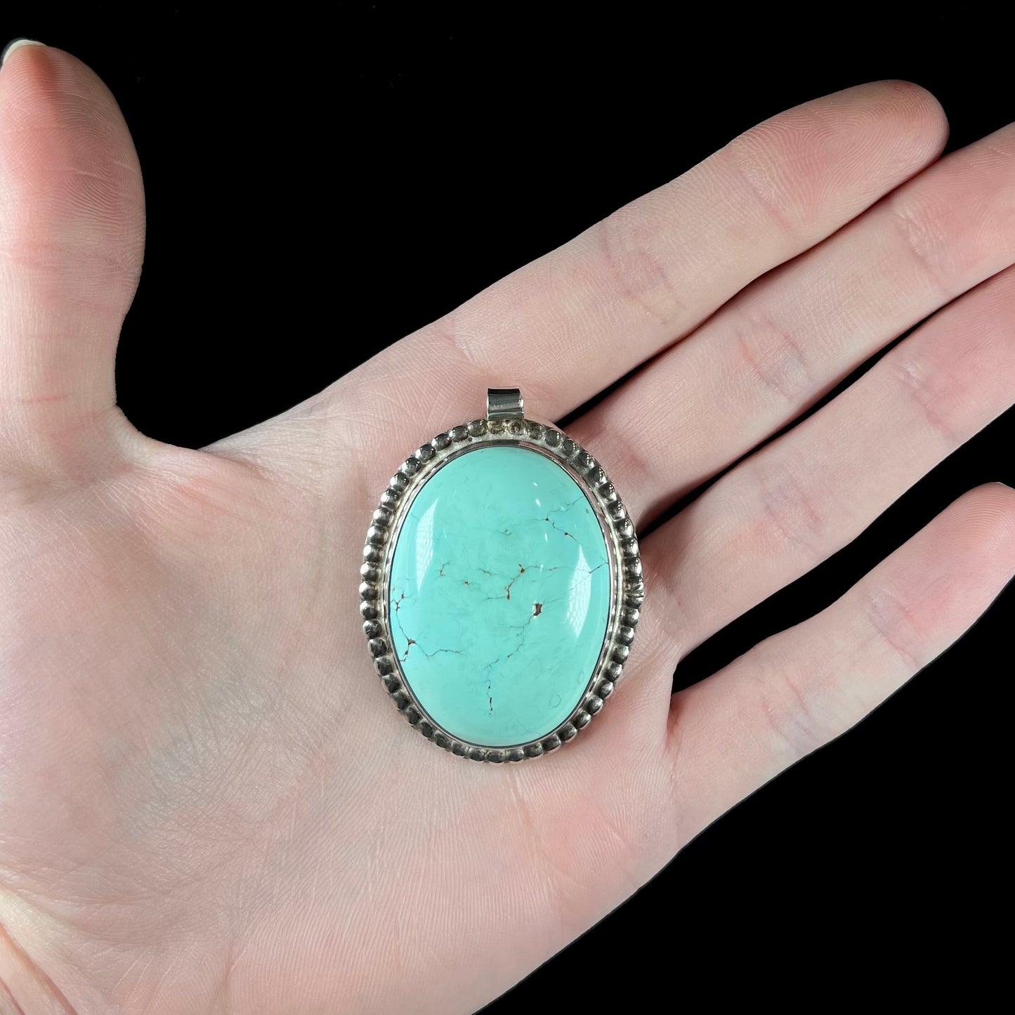 A sterling silver Native American pendant set with a piece of blue turquoise from Courtland-Gleeson Mining District, Arizona.