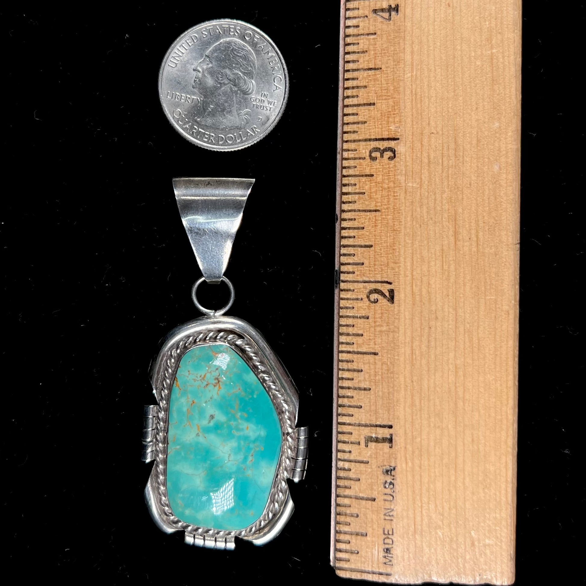 A men's silver Navajo pendant set with a turquoise stone from Pilot Mountain Mine, Nevada.