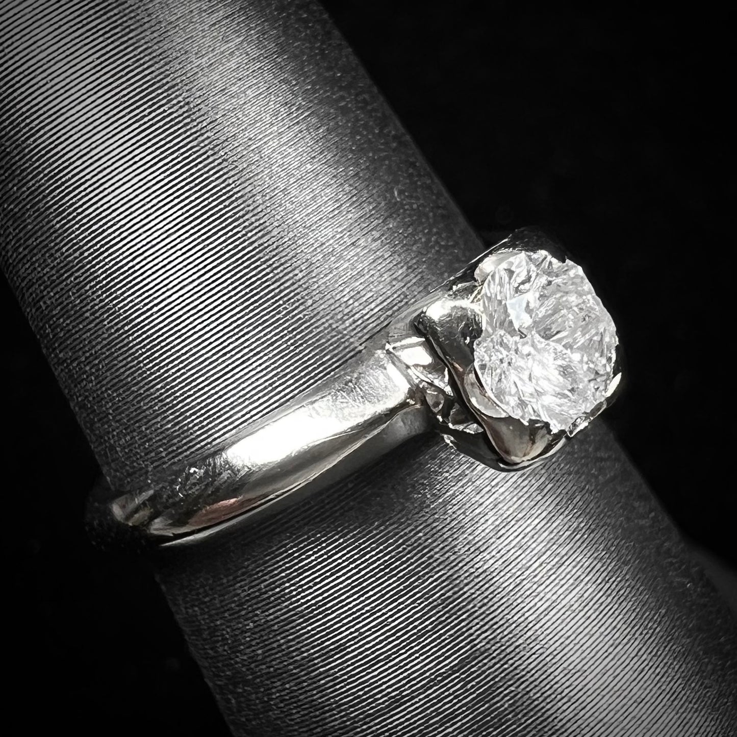 A ladies' vintage 14kt white gold 1940's diamond solitaire ring. The diamond is chipped in two places.
