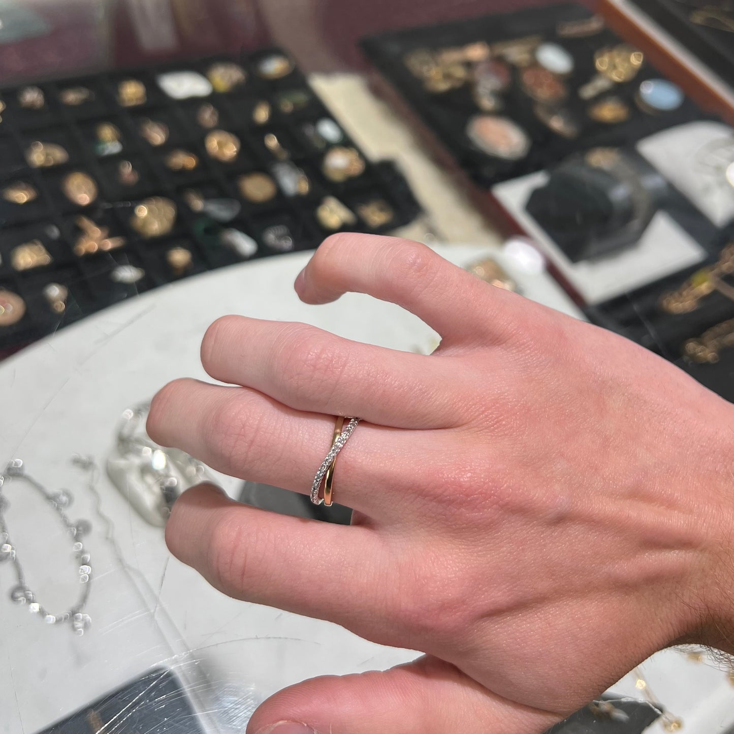 A ladies' two tone yellow and white gold twisted shank ring pave set with round single cut diamonds.