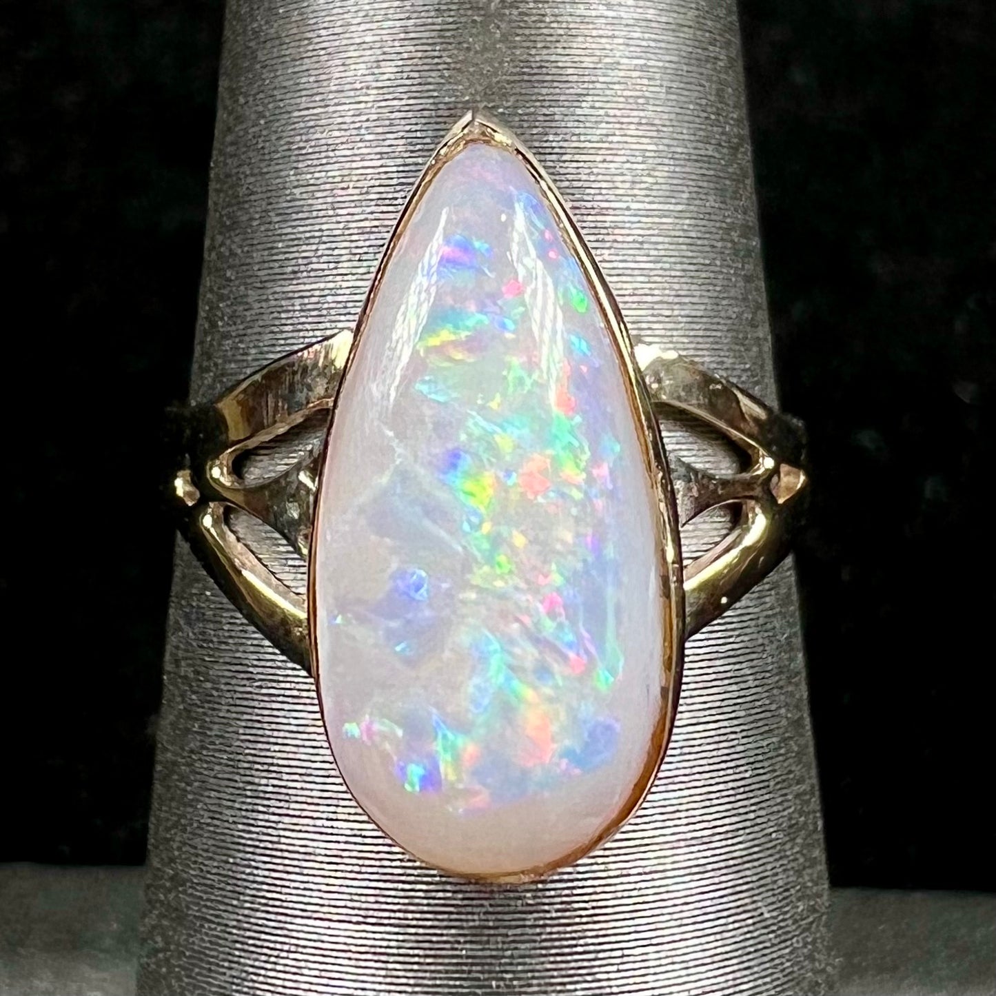 A ladies' pear shaped white crystal opal solitaire ring handmade in yellow gold.