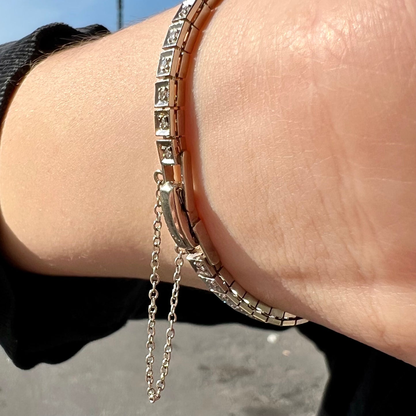 A vintage, art deco style white gold and diamond bracelet set with a rectangular shape black boulder opal stone.