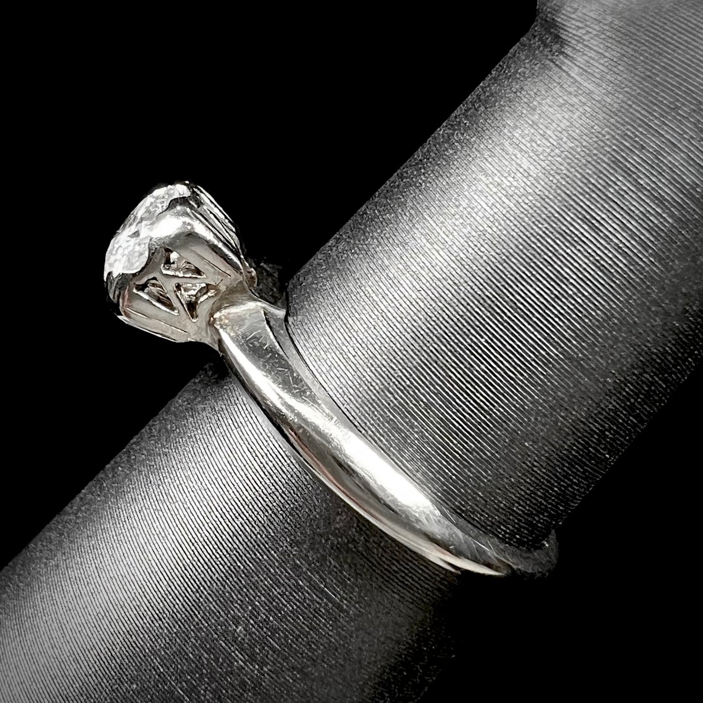 A ladies' vintage 14kt white gold 1940's diamond solitaire ring. The diamond is chipped in two places.