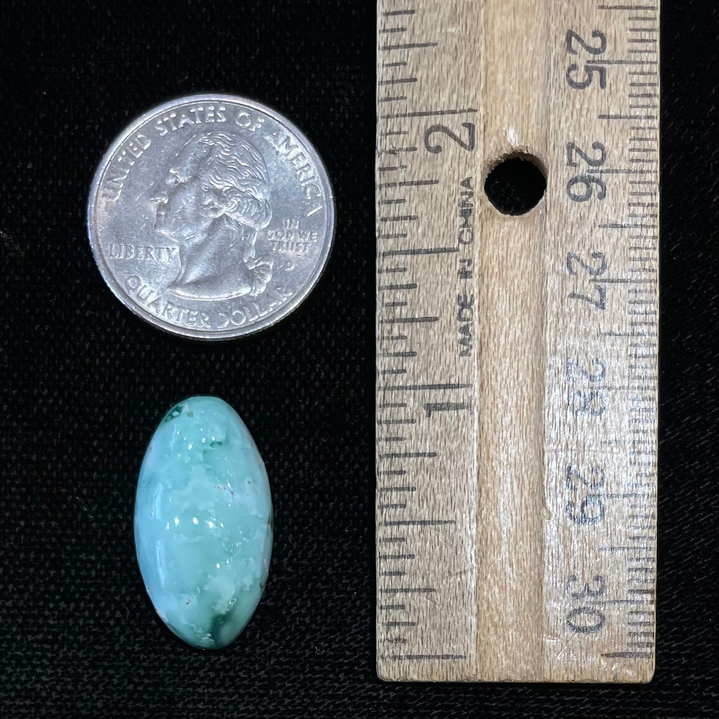 A loose, oval cabochon cut variscite stone from Utah, USA.