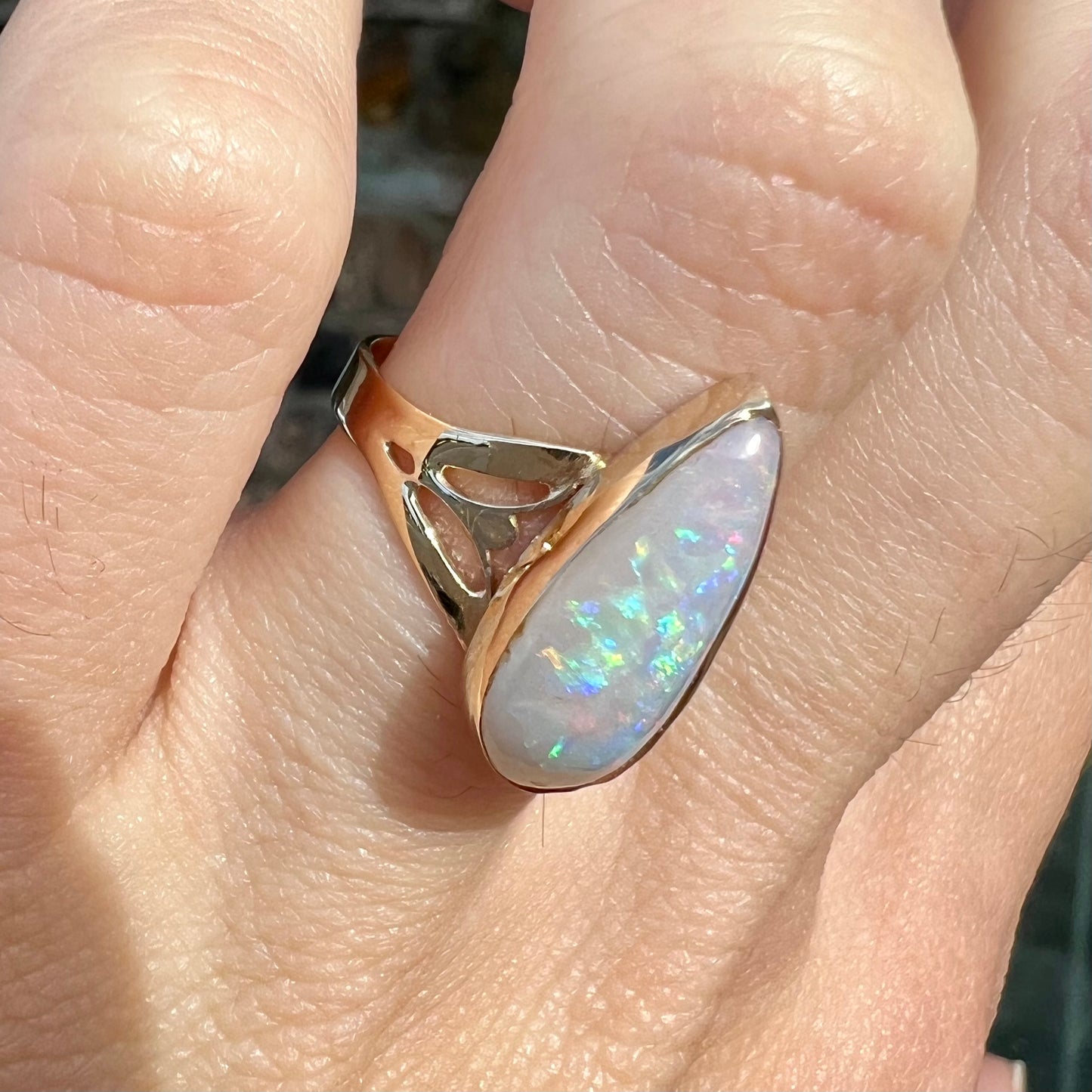 A ladies' pear shaped white crystal opal solitaire ring handmade in yellow gold.