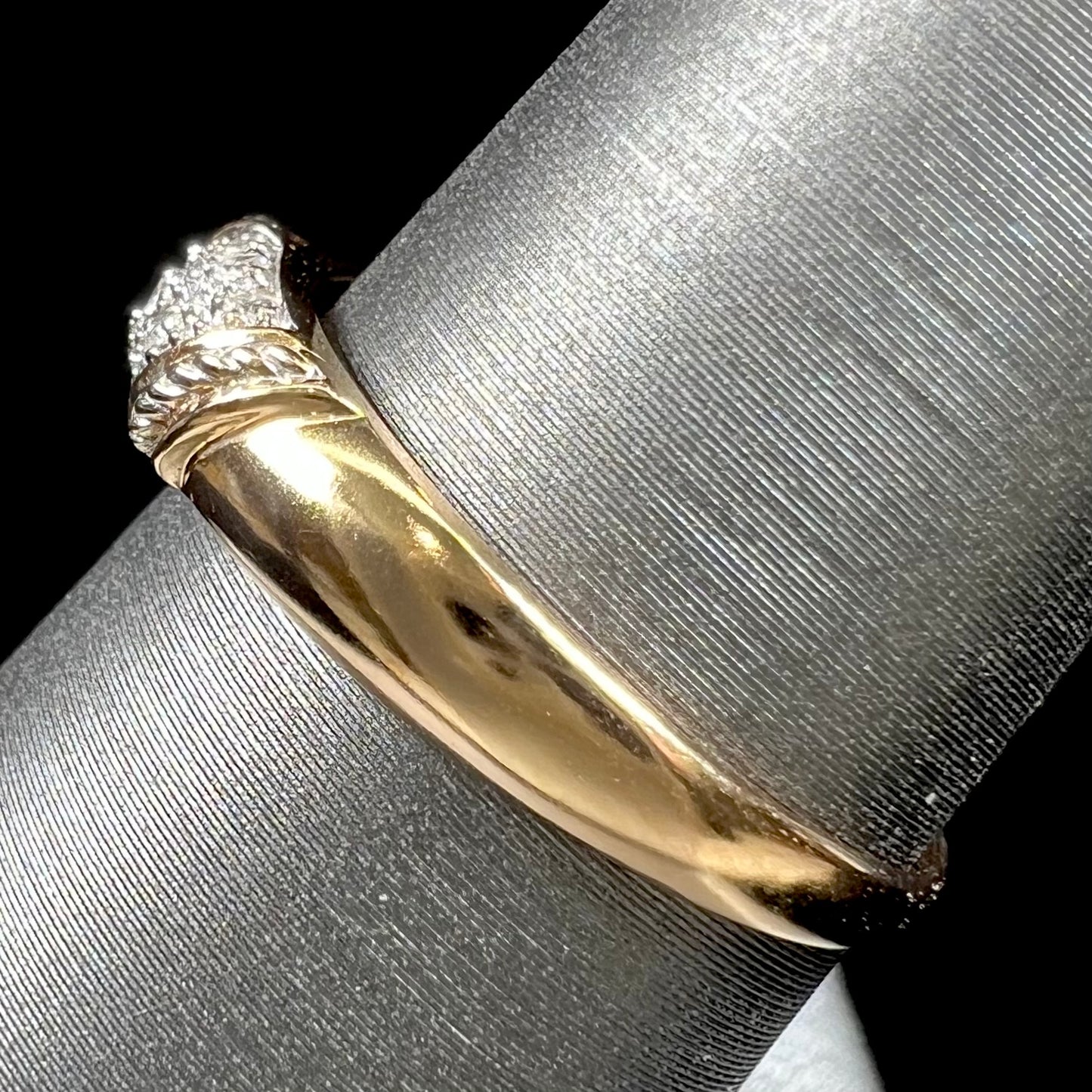 A unisex 18k yellow gold diamond ring pave set with round single cut diamonds.