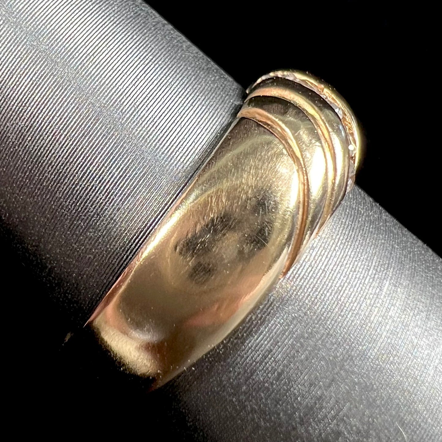 A ladies' channel set gold diamond ring.