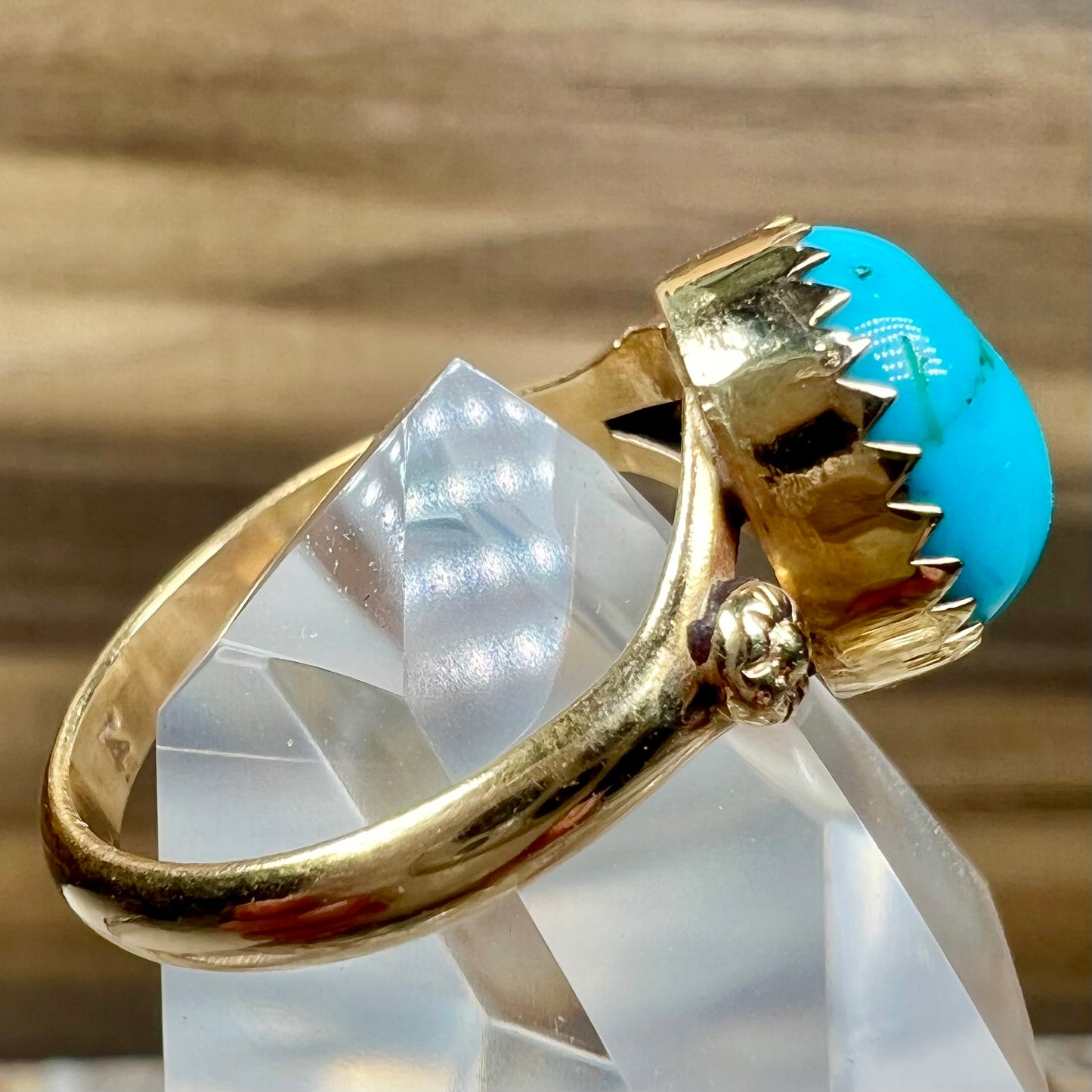 A ladies' yellow gold turquoise ring. The turquoise is a round cabochon cut.