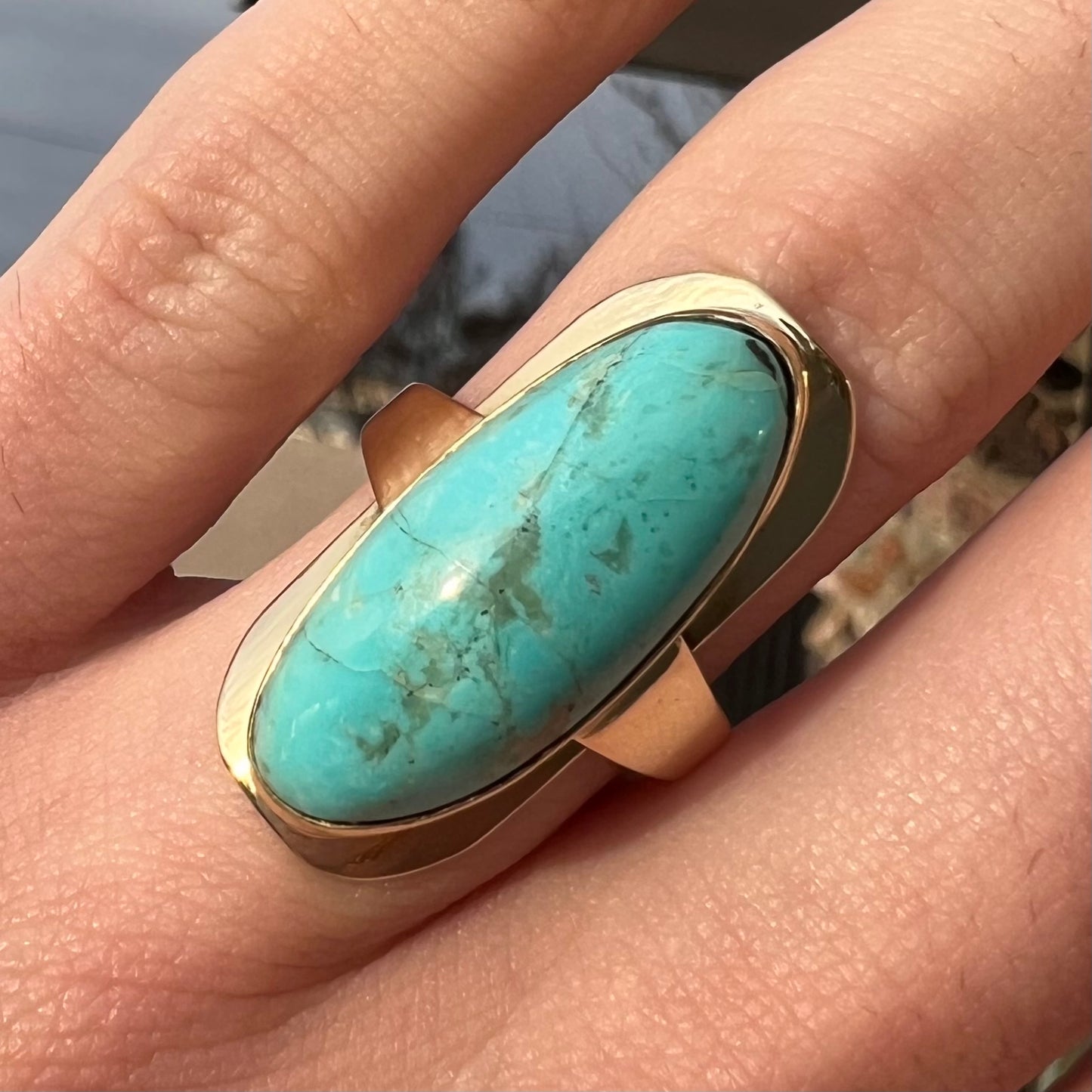 A Sleeping Beauty turquoise solitaire ring cast in 14kt yellow gold.