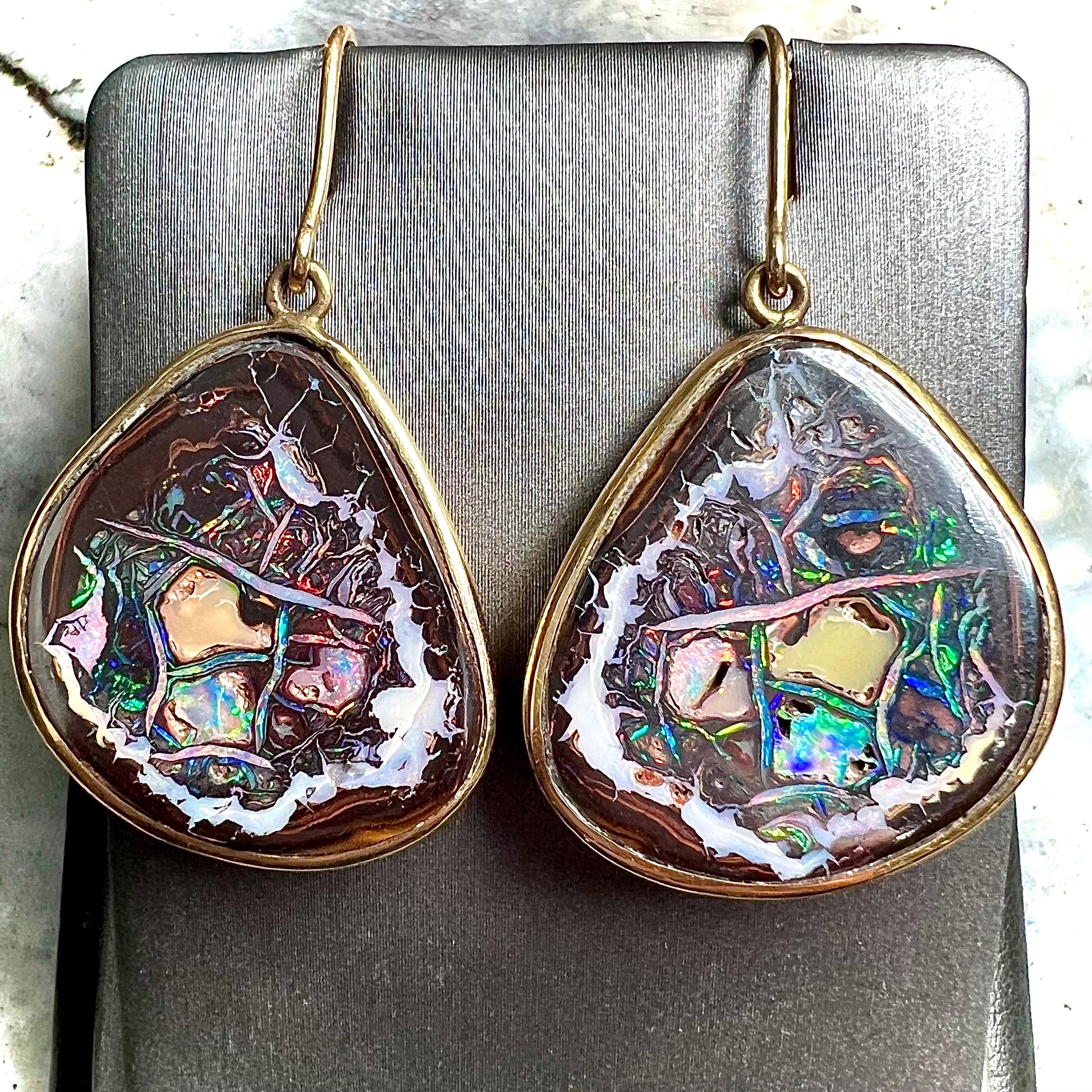 A pair of yellow gold bezel set Yowah nut boulder opal dangle earrings.