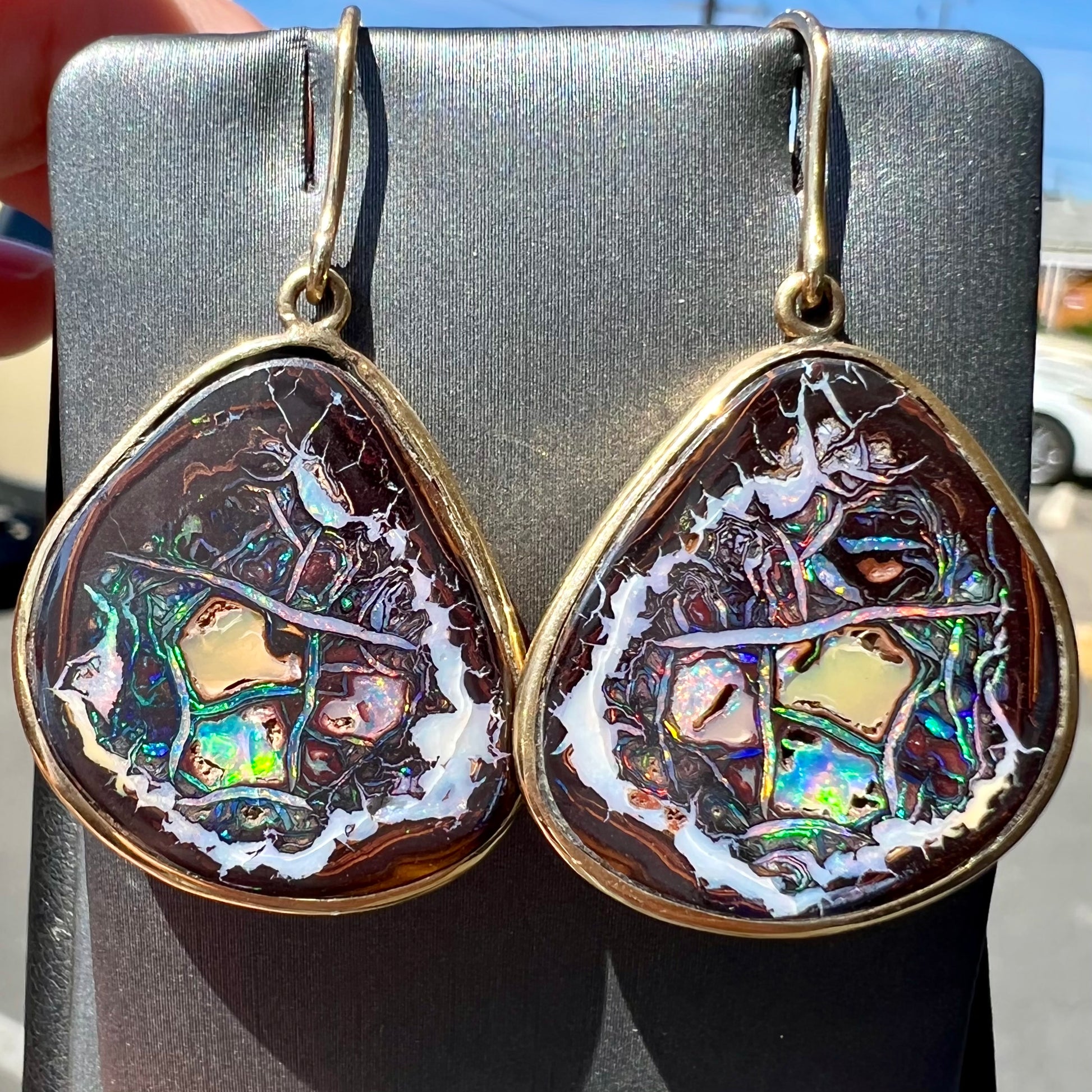 A pair of yellow gold bezel set Yowah nut boulder opal dangle earrings.