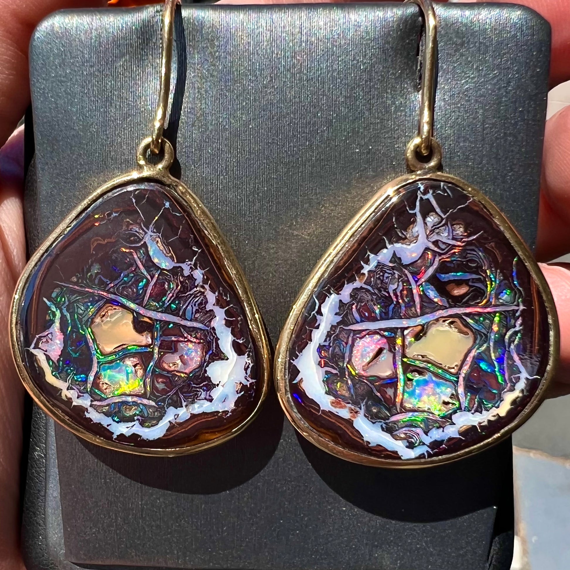 A pair of yellow gold bezel set Yowah nut boulder opal dangle earrings.