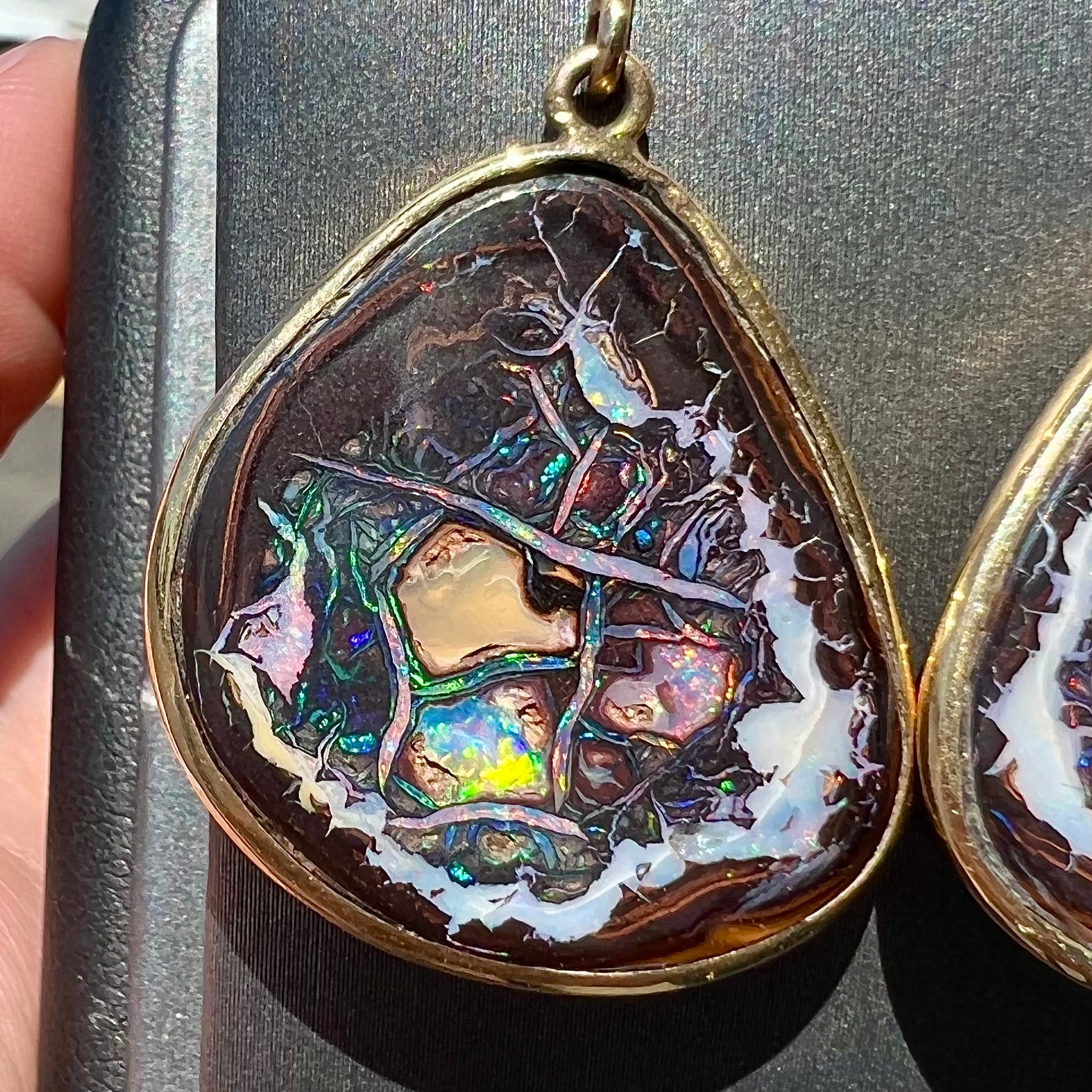 A pair of yellow gold bezel set Yowah nut boulder opal dangle earrings.