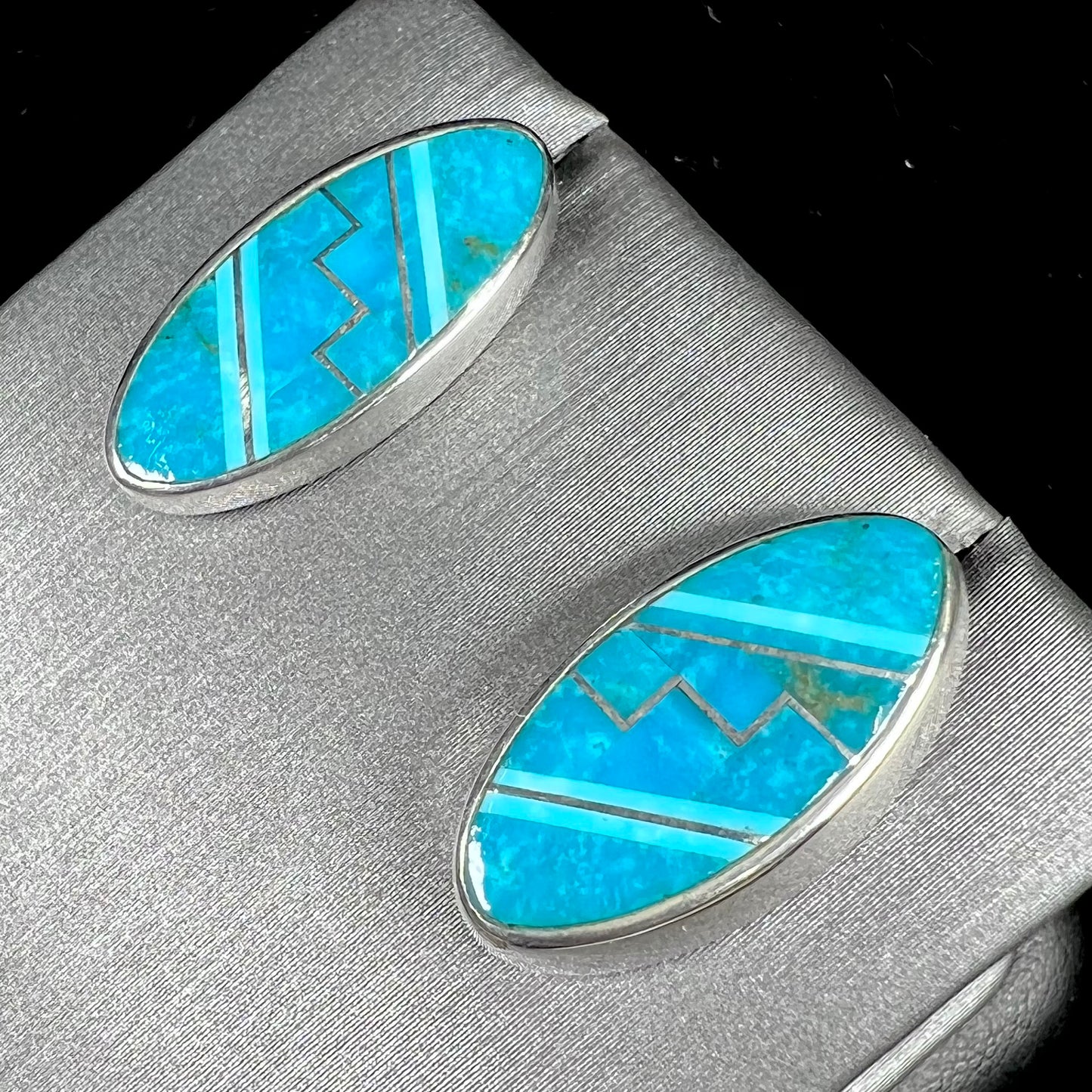 A pair of sterling silver turquoise inlay earrings, handmade by the Zuni artist.