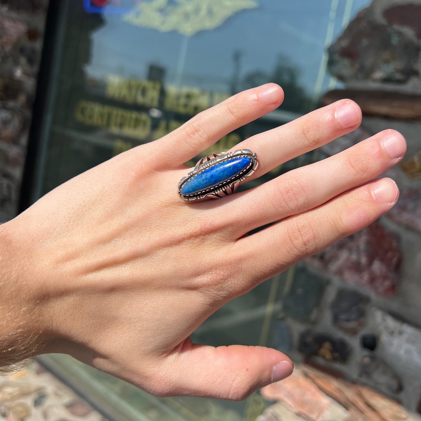 A Navajo style sterling silver lapis lazuli ring engraved with the words "R. Bennett".