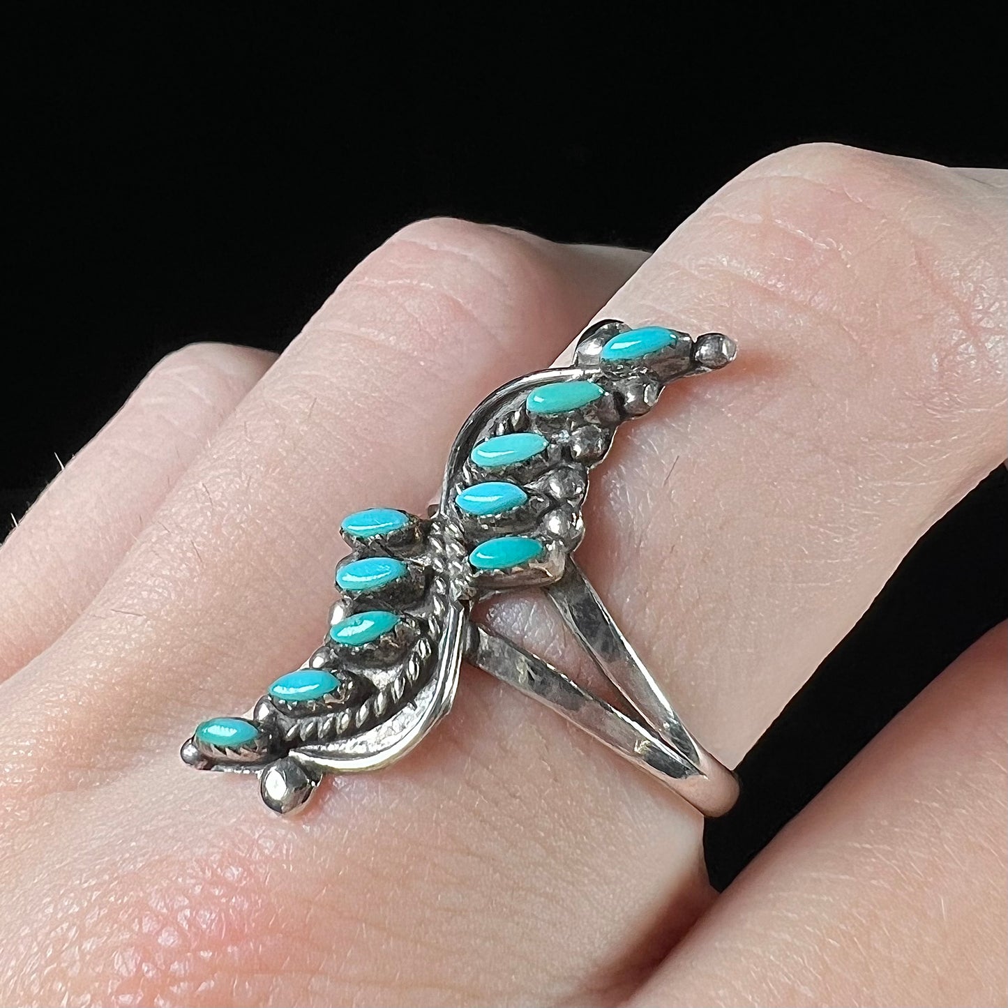 A Zuni needlepoint turquoise ring set in sterling silver.