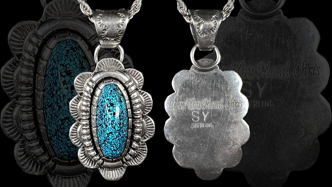 A Southwest style pendant handmade from sterling silver with a black spiderweb turquoise stone from Kingman, Arizona, by Sam Yah.