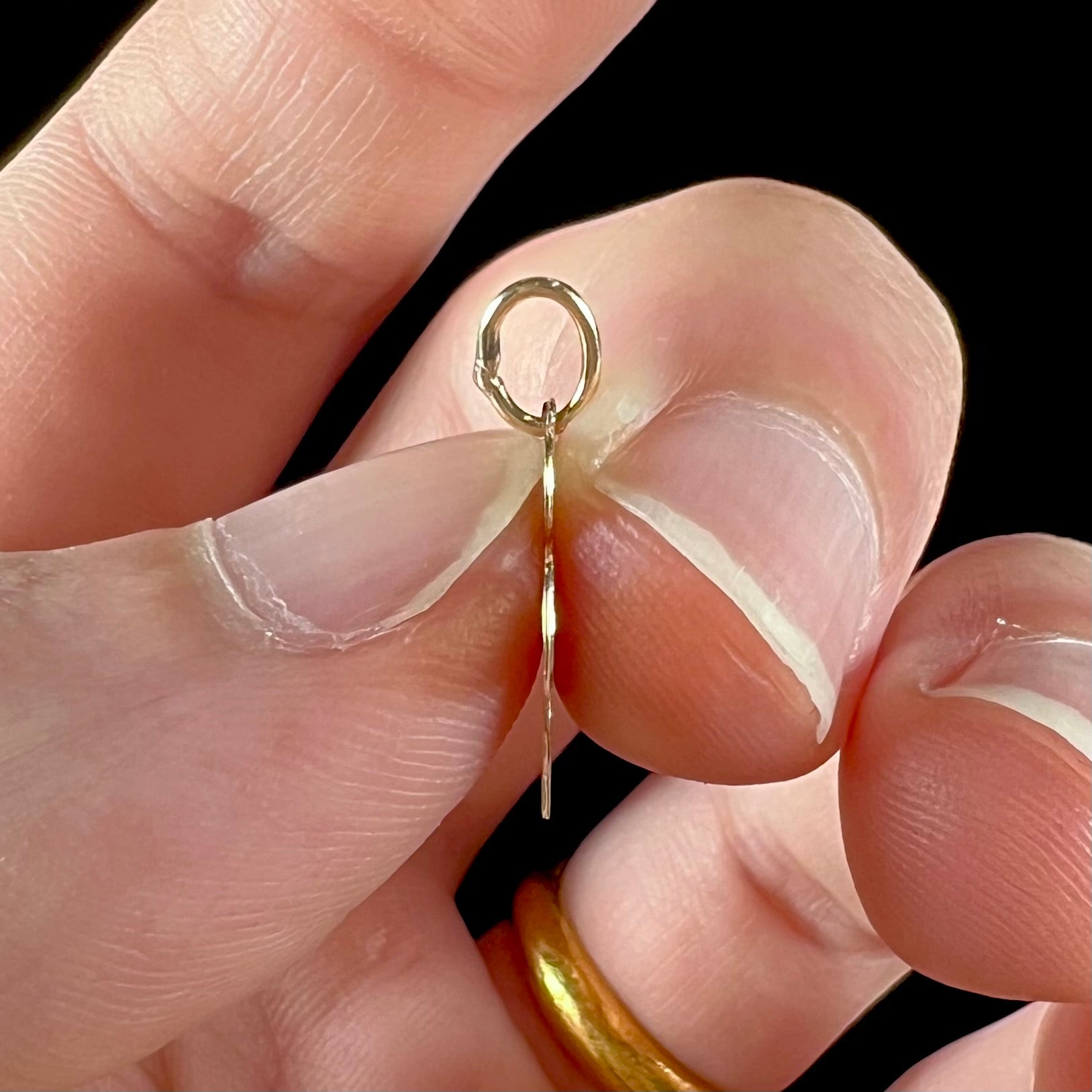 A dainty yellow gold Minnie Mouse pendant.