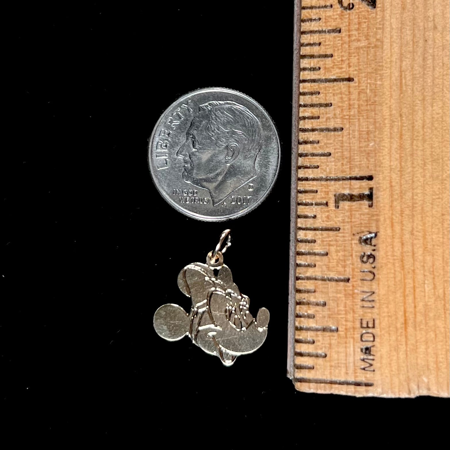 A dainty yellow gold Minnie Mouse pendant.
