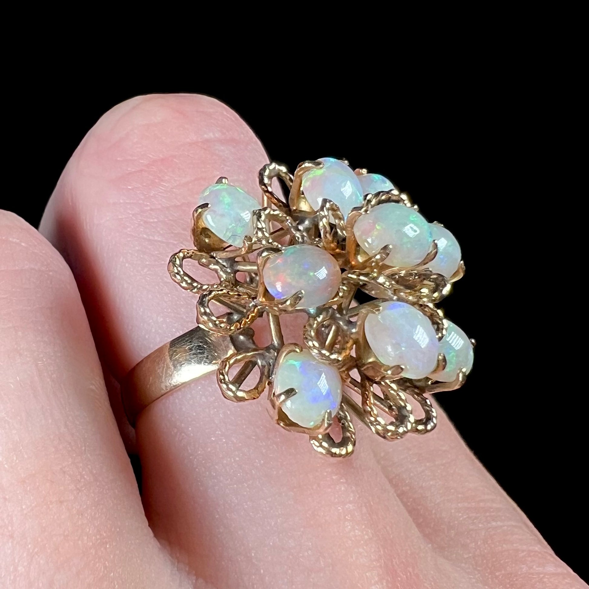 A ladies' yellow gold opal cluster ring.  The ring is an atomic motif, handmade in the mid-century modern style.