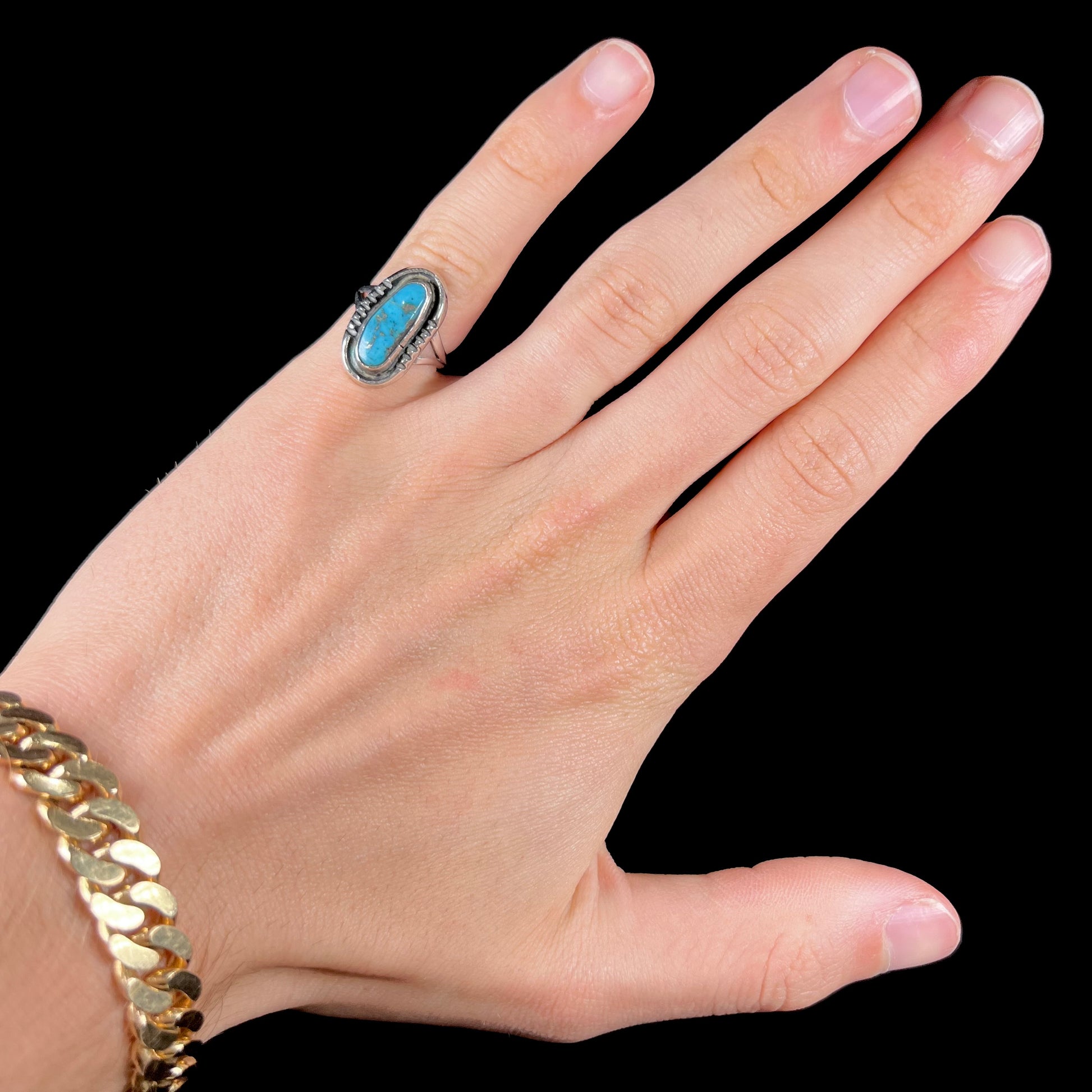 A handmade sterling silver Navajo style ring set with a Morenci turquoise stone.