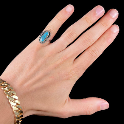 A handmade sterling silver Navajo style ring set with a Morenci turquoise stone.