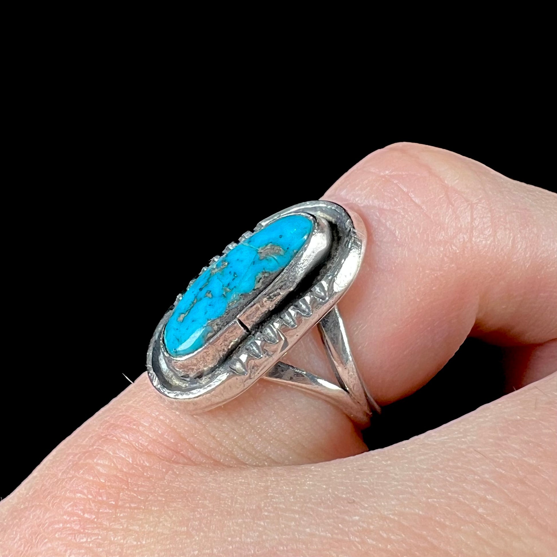 A handmade sterling silver Navajo style ring set with a Morenci turquoise stone.