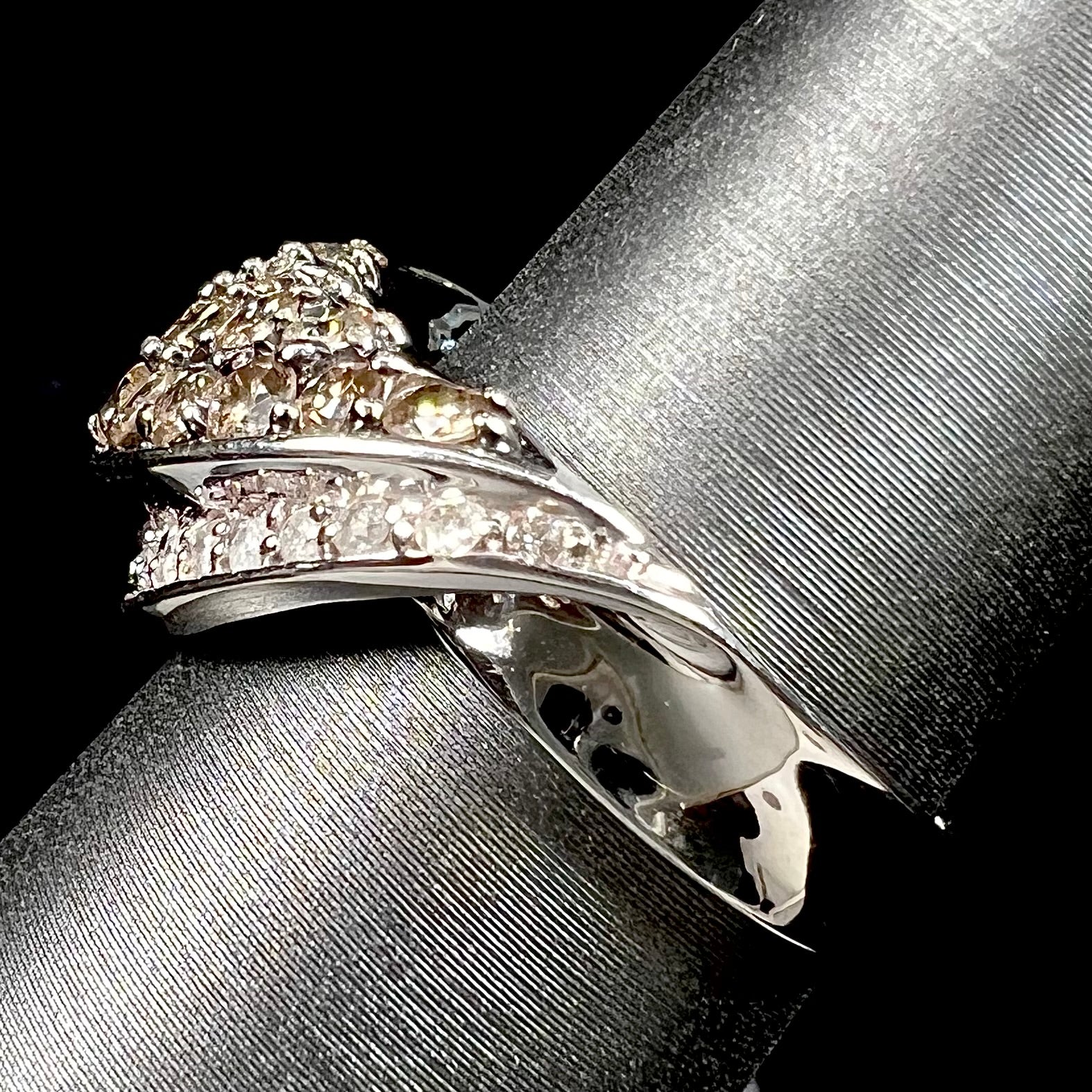 A ladies' white gold ring set with clusters of brown champagne and white diamonds.