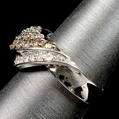 A ladies' white gold ring set with clusters of brown champagne and white diamonds.