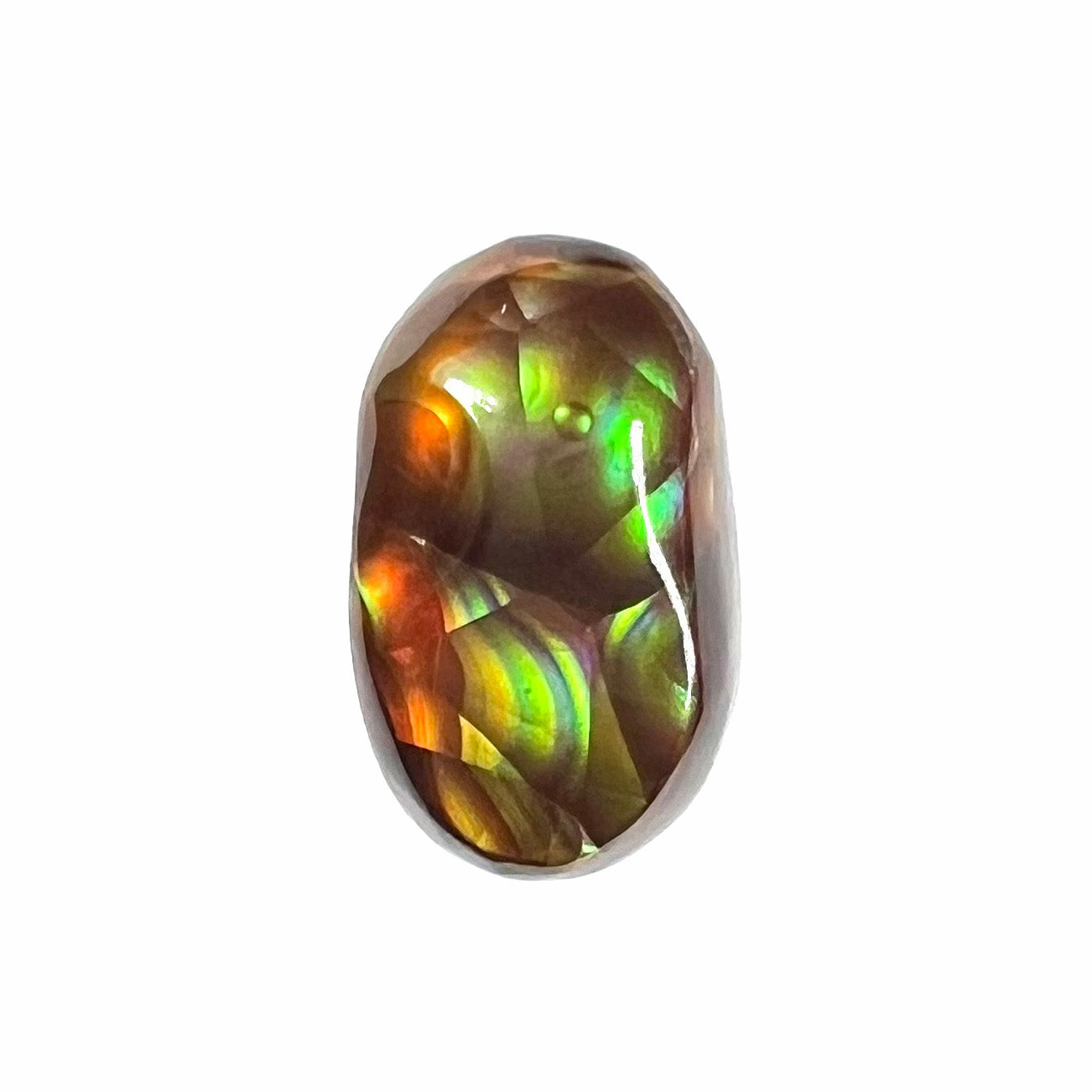 A loose, oval cabochon cut Mexican fire agate stone.  The stone has multi-colored banding with blue overtones.