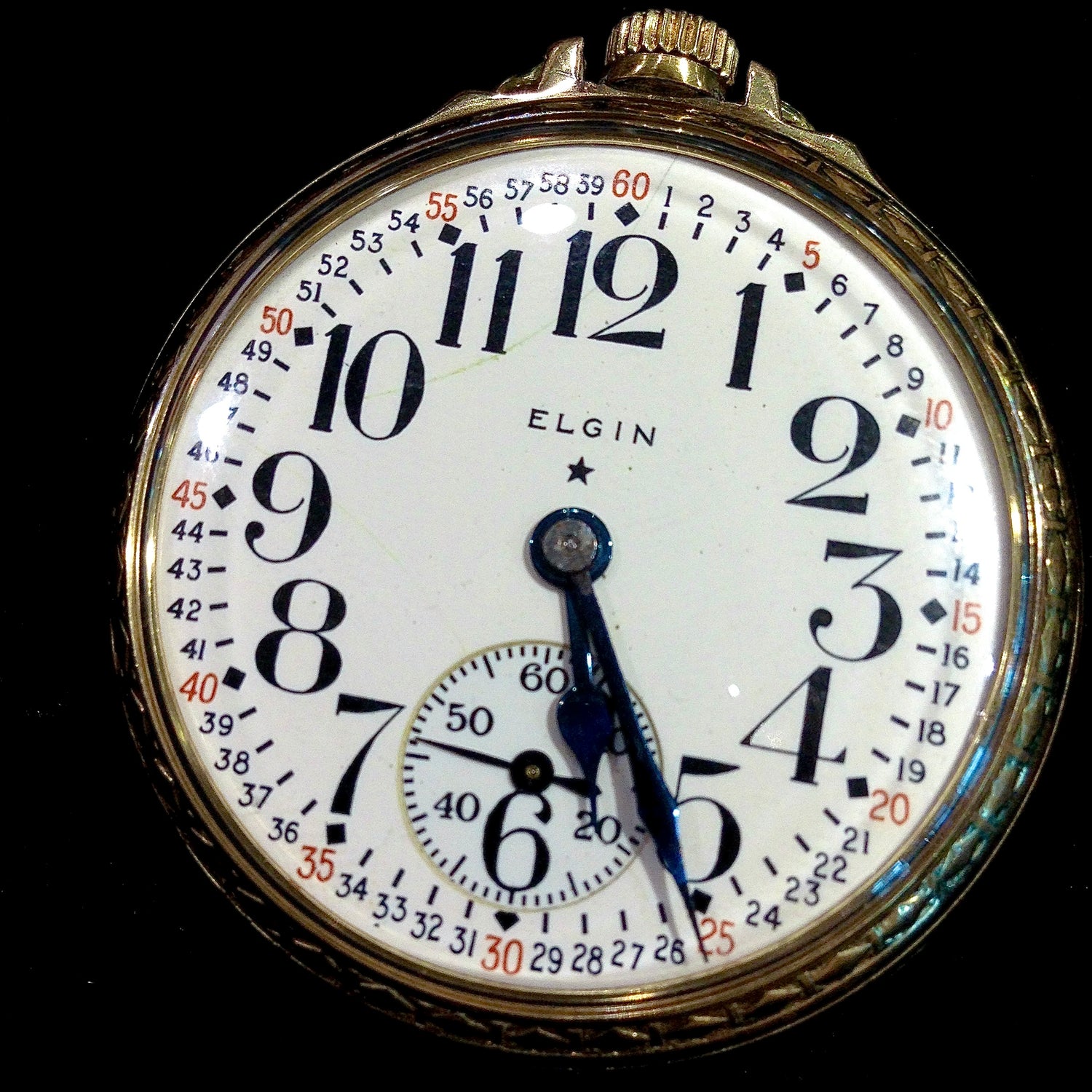 An antique yellow gold railroad Elgin pocket watch.