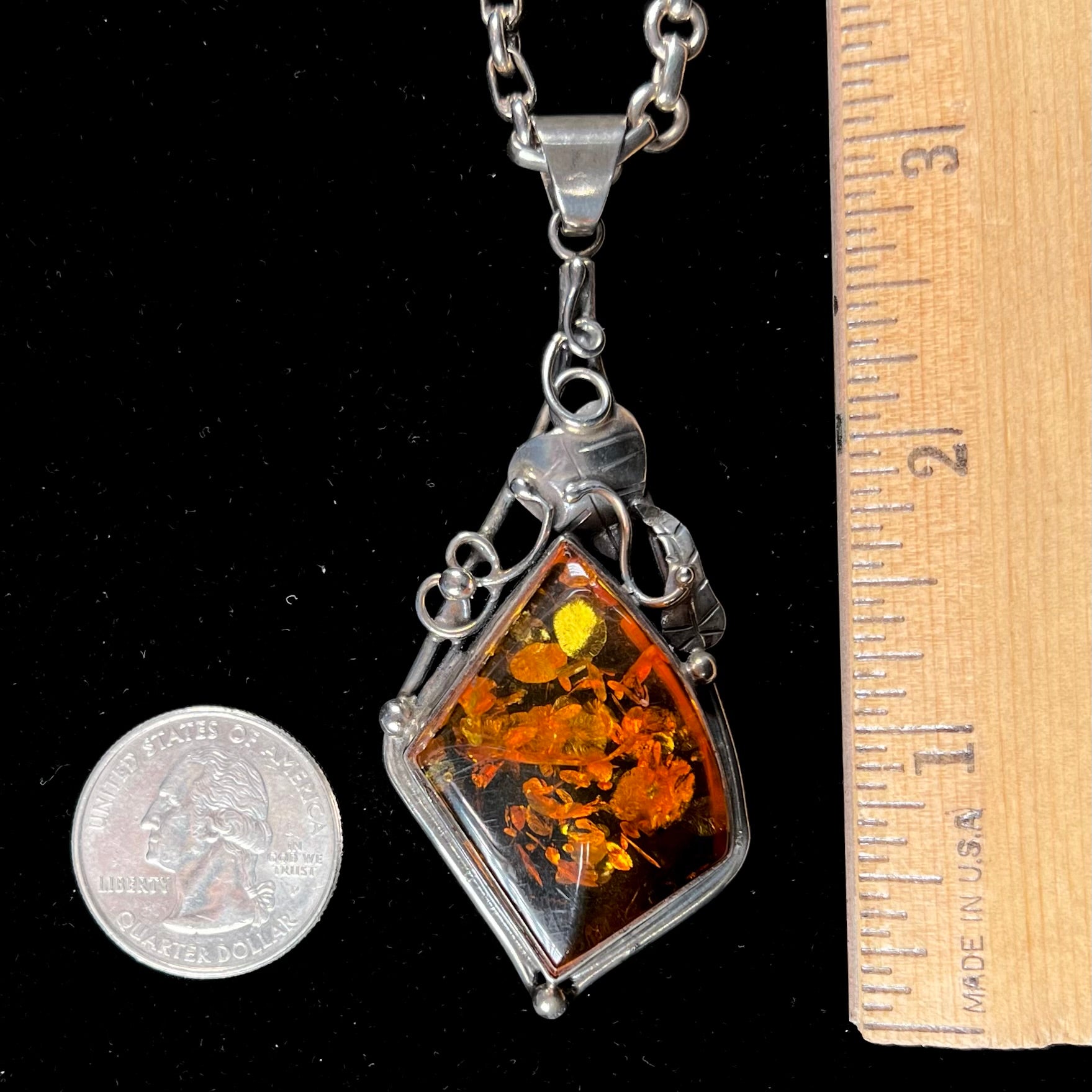 Unisex silver pendant set with a sun-spangled Mexican amber stone, featuring silver leaf design accents.