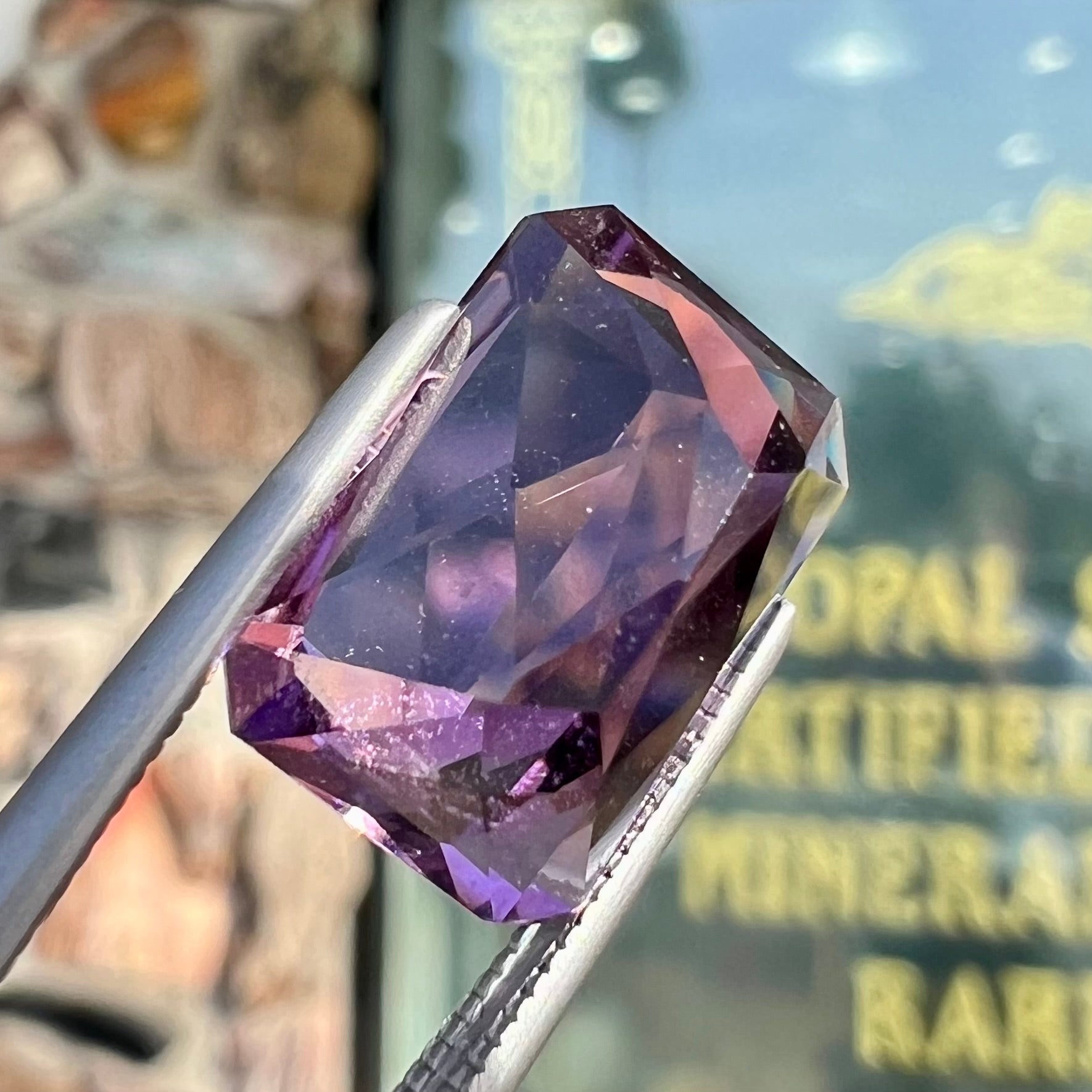 A loose, modified radiant cut amethyst stone.