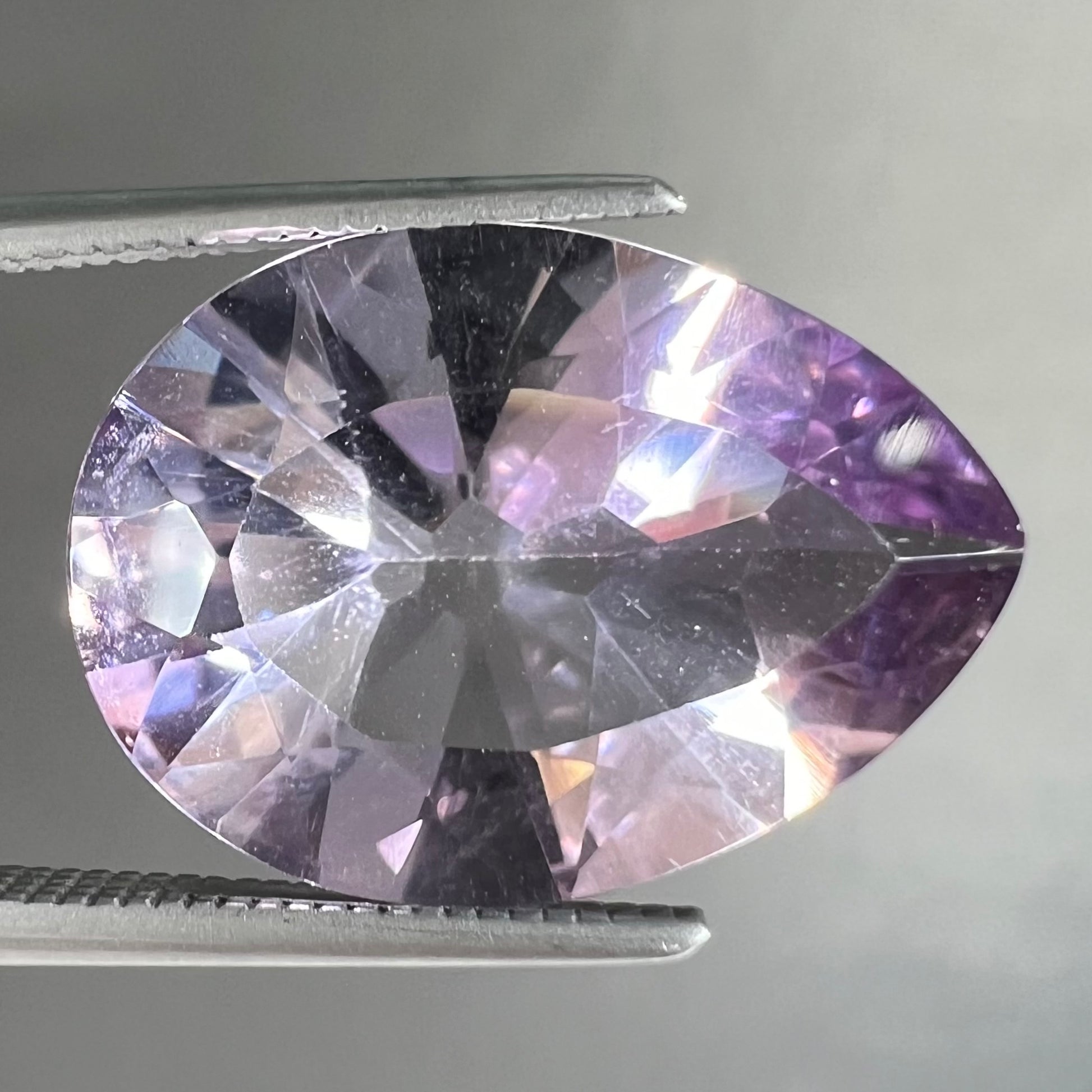 A faceted pear shaped rose de France colored amethyst gemstone.