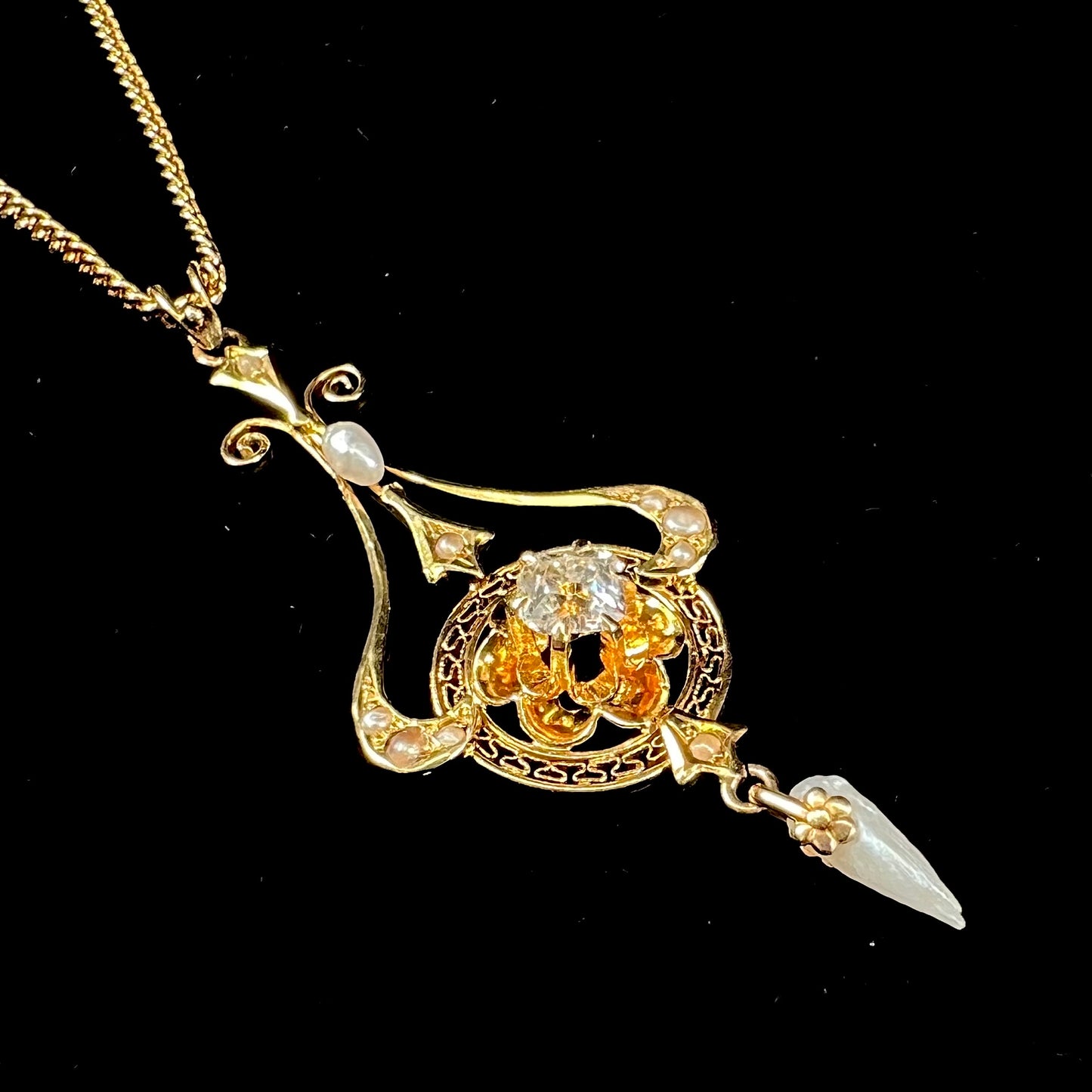 A ladies' Edwardian style gold necklace set with pearls and an old mine cut diamond.  The chain is marked "1916".